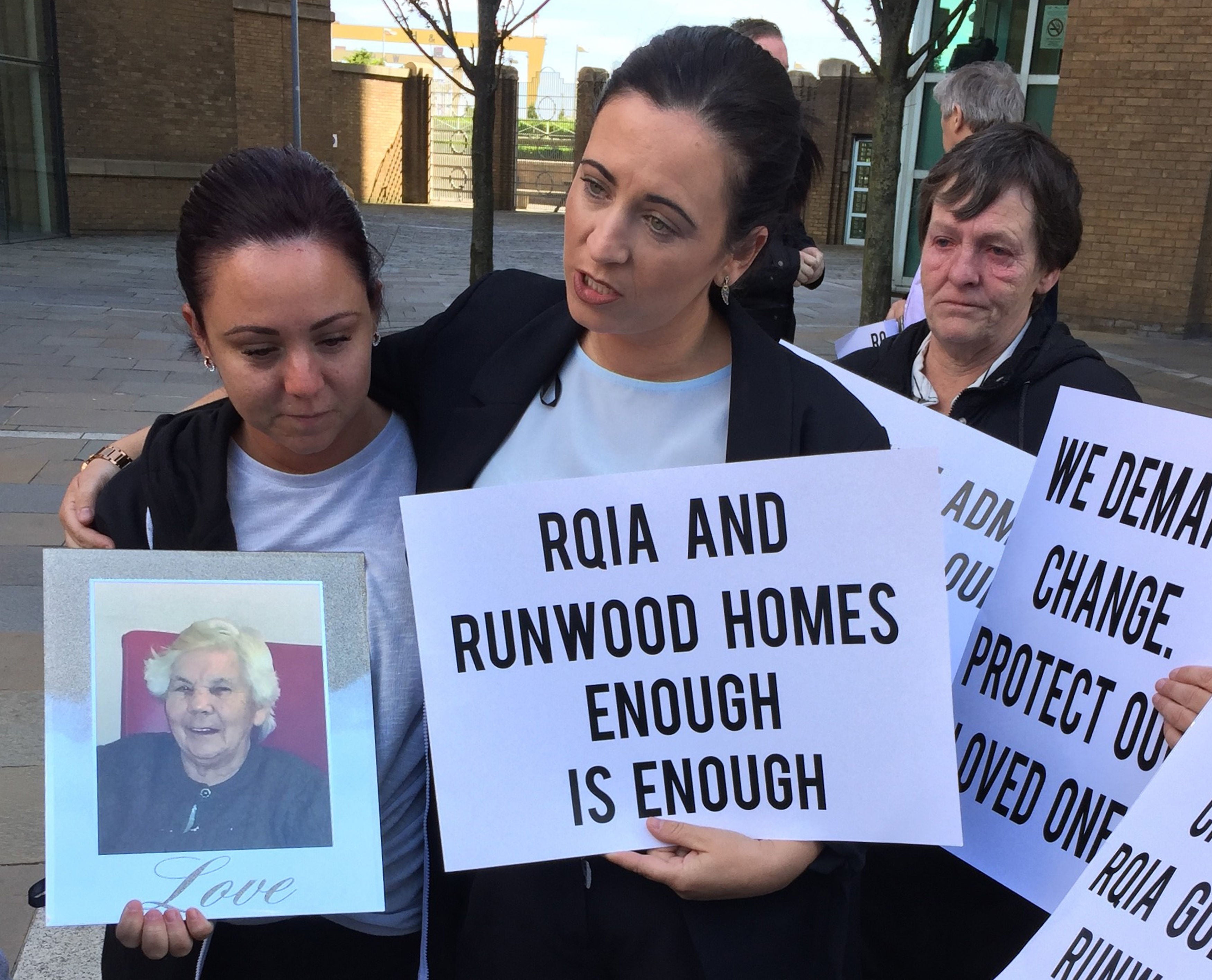 Julie Ann McNally (centre) the granddaughter of Annie McCourt protests outside the Regulation and Quality Improvement Authority (RQIA) in Belfast a week after a damning report into standards at the Dunmurry Manor home. The 89-year-old great grandmother from west Belfast, who suffered from dementia, was a resident at the home for six months in 2016. She died later that year.