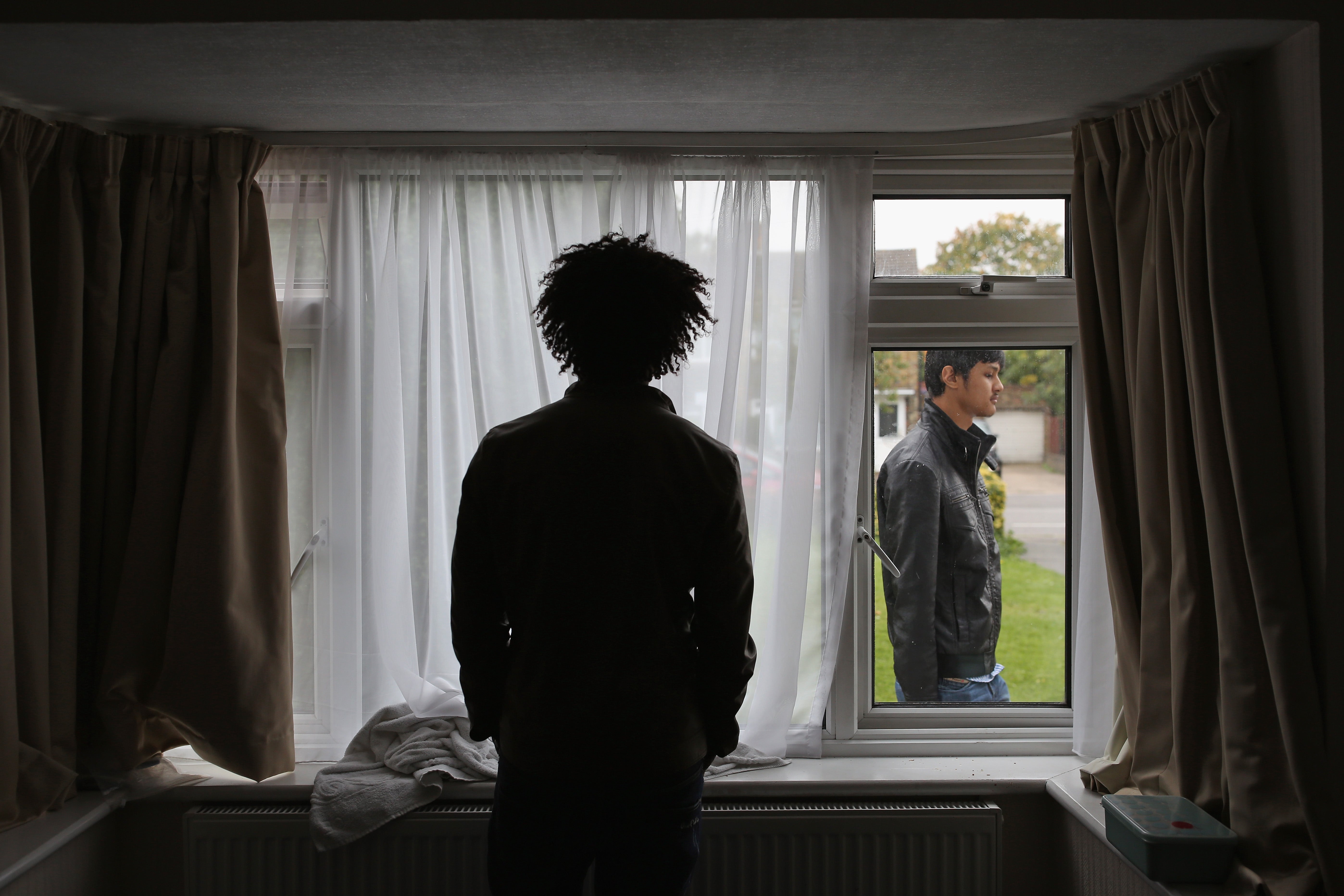 A refugee from Eritrea stands in his single room