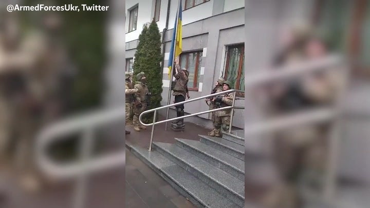 Ukraine flag raised by soldiers in Bucha after city suffers devastation from Russian attack