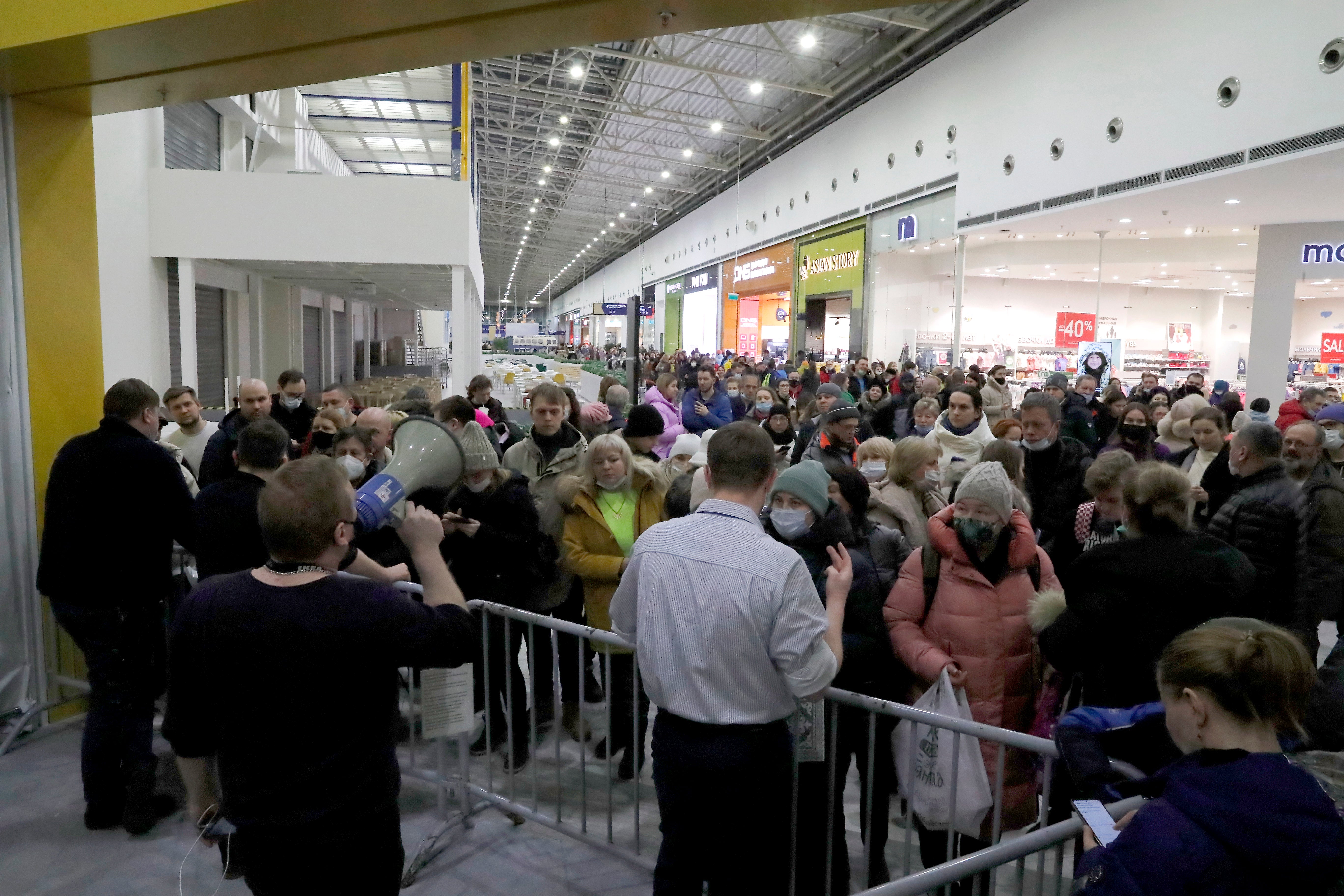 Russian people stay in line in Ikea hypermarket before the store closes in St. Petersburg, Russia.