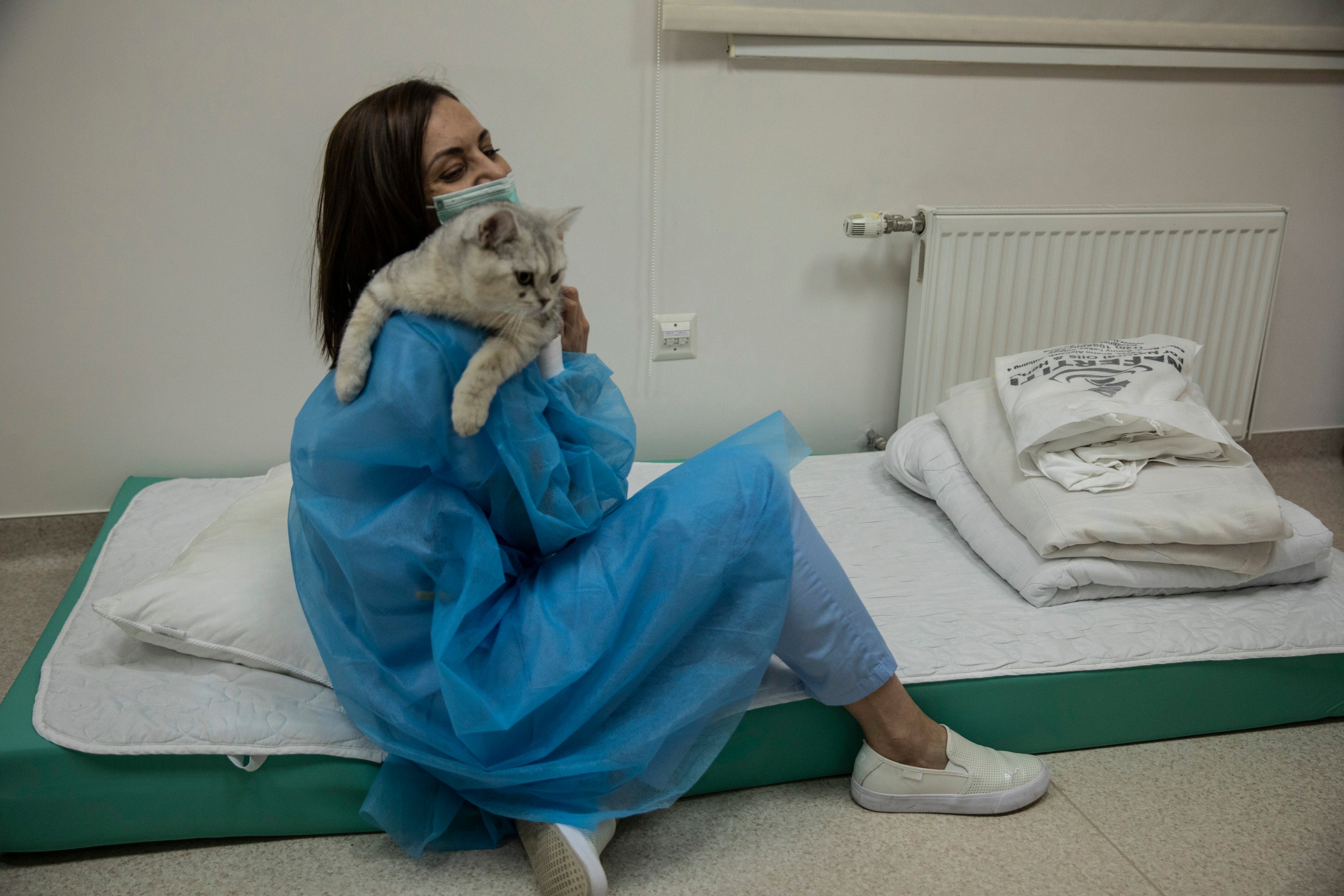 Saar Yuniuta, medical director of the Isida clinic, with her pet cat in her office in Kyiv