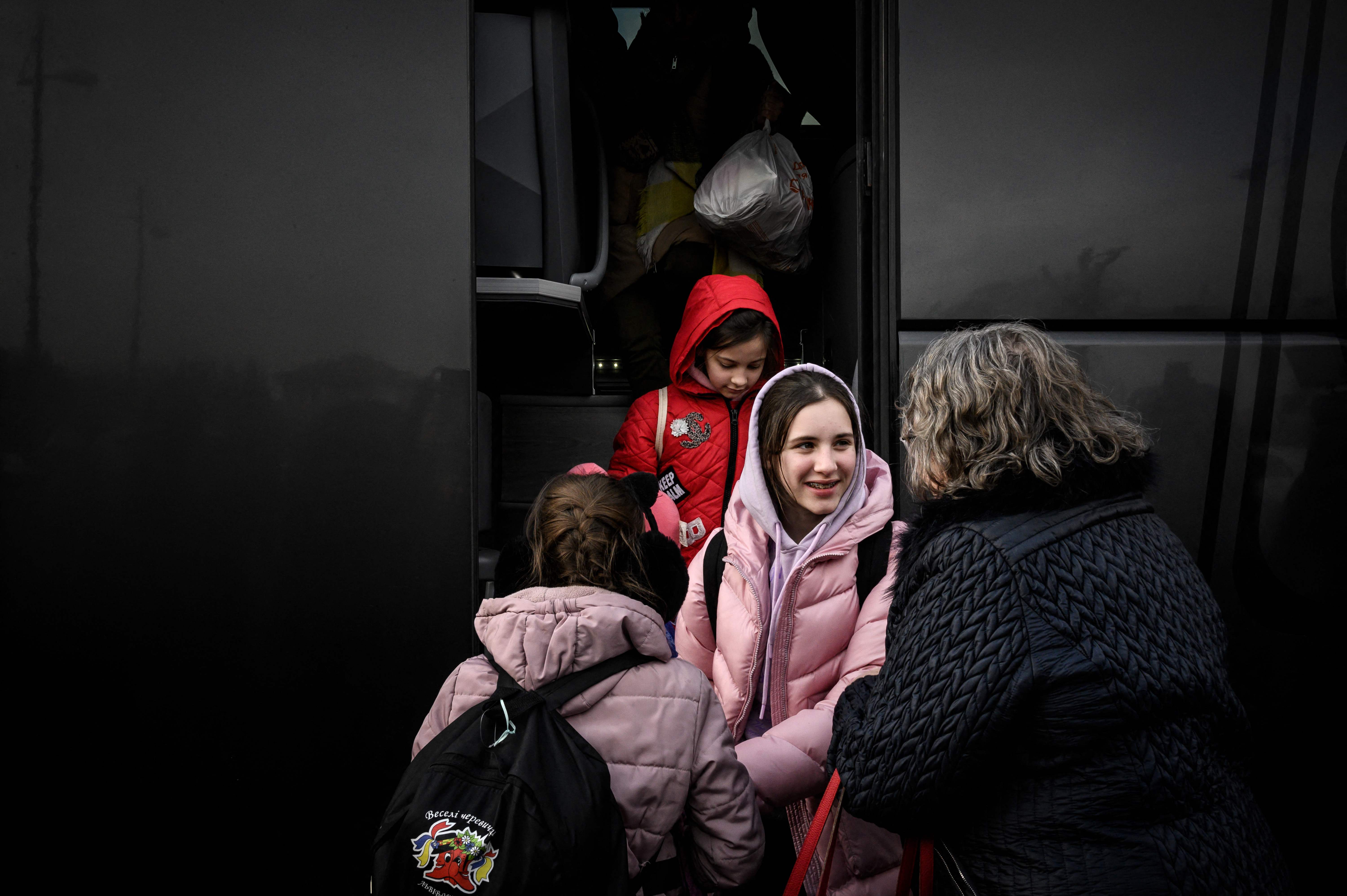 Refugees from Ukraine are welcomed as they arrive by bus in Saint-Pierre-de-Chandieu, eastern France