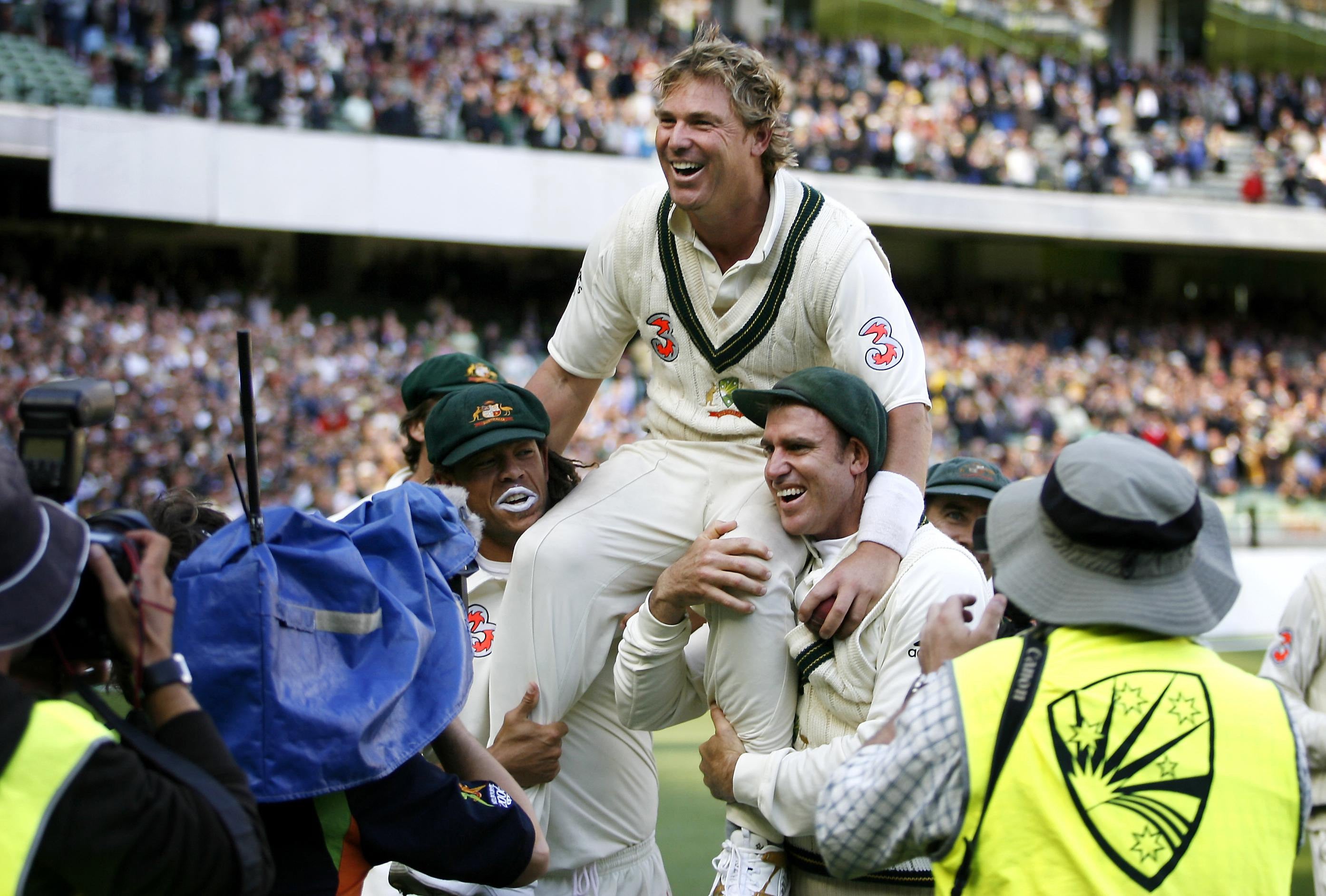 Australia’s man-of-the-match Warne is carried from the field by team-mates Andrew Symonds and Matthew Hayden after victory on the third day of the fourth Test against England at the MCG in Melbourne in December 2006 (Gareth Copley/PA)