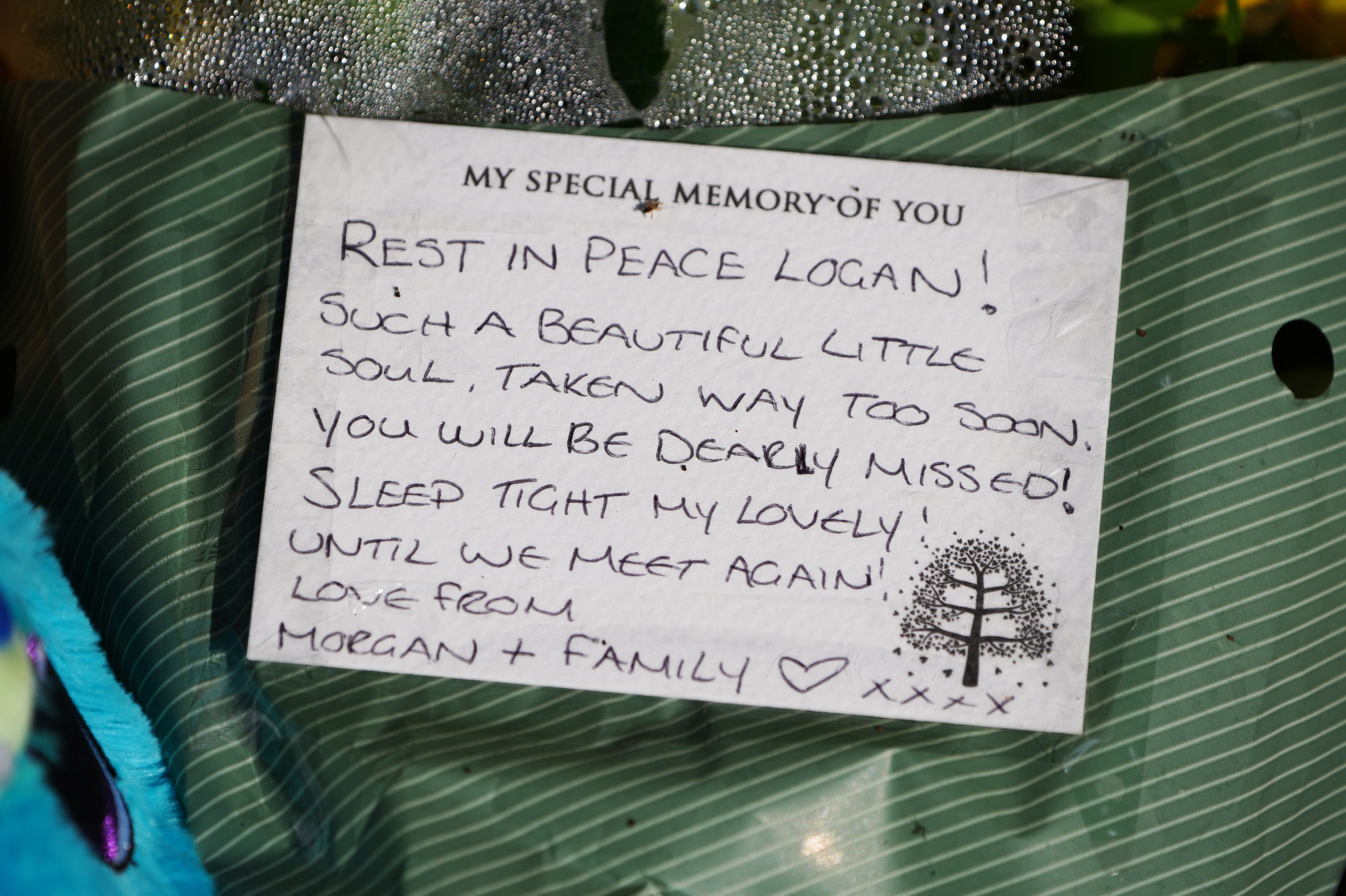 Tributes left at the scene in the Sarn area of Bridgend, south Wales, near to where five-year-old Logan Mwangi was found dead.