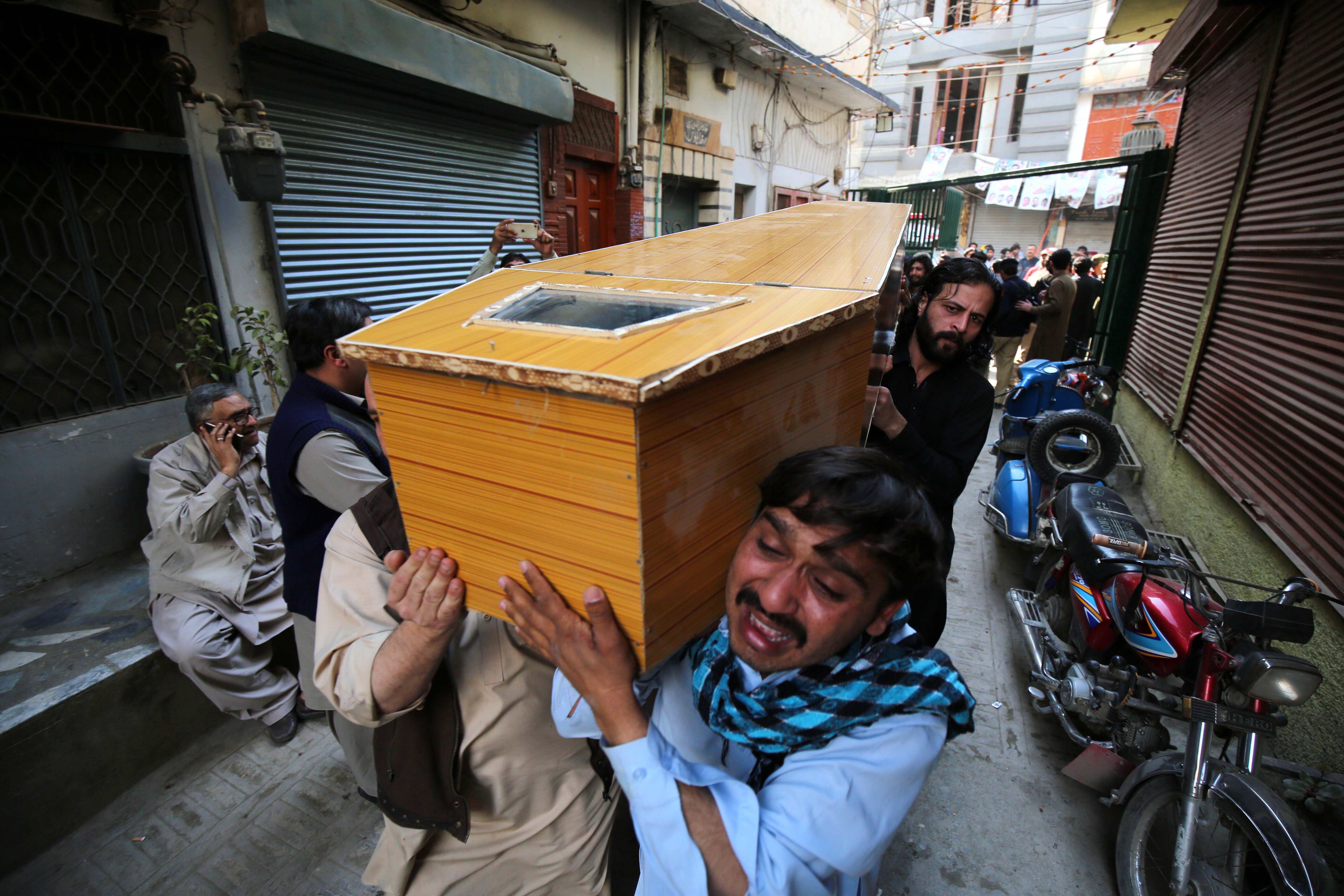 People carry the coffin of a victim of the blast