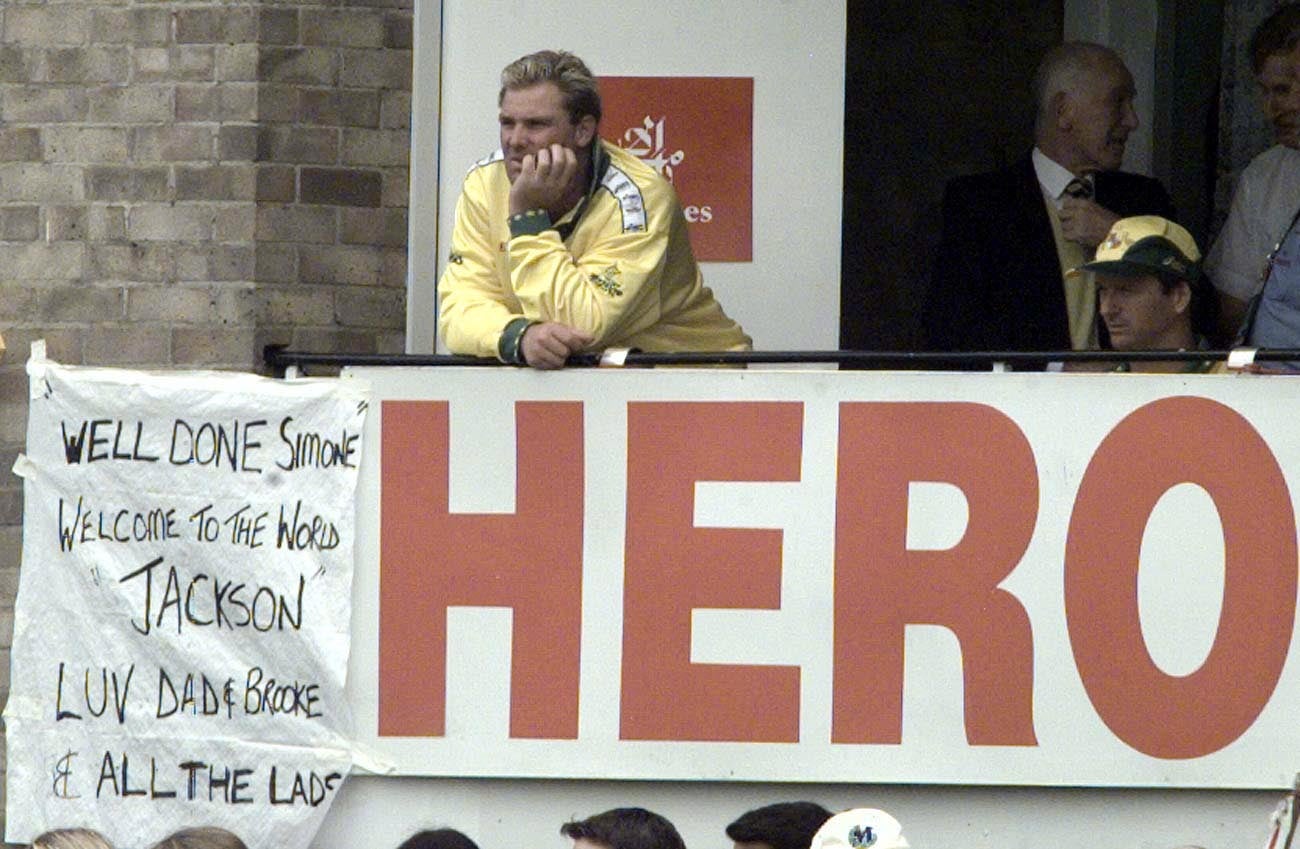 Australia bowler Shane Warne, during a Cricket World Cup match against New Zealand at Sophia Gardens in Cardiff, stands above a message on the team balcony congratulating his wife Simone on the birth of their son Jackson in 1999 (David Jones/PA)