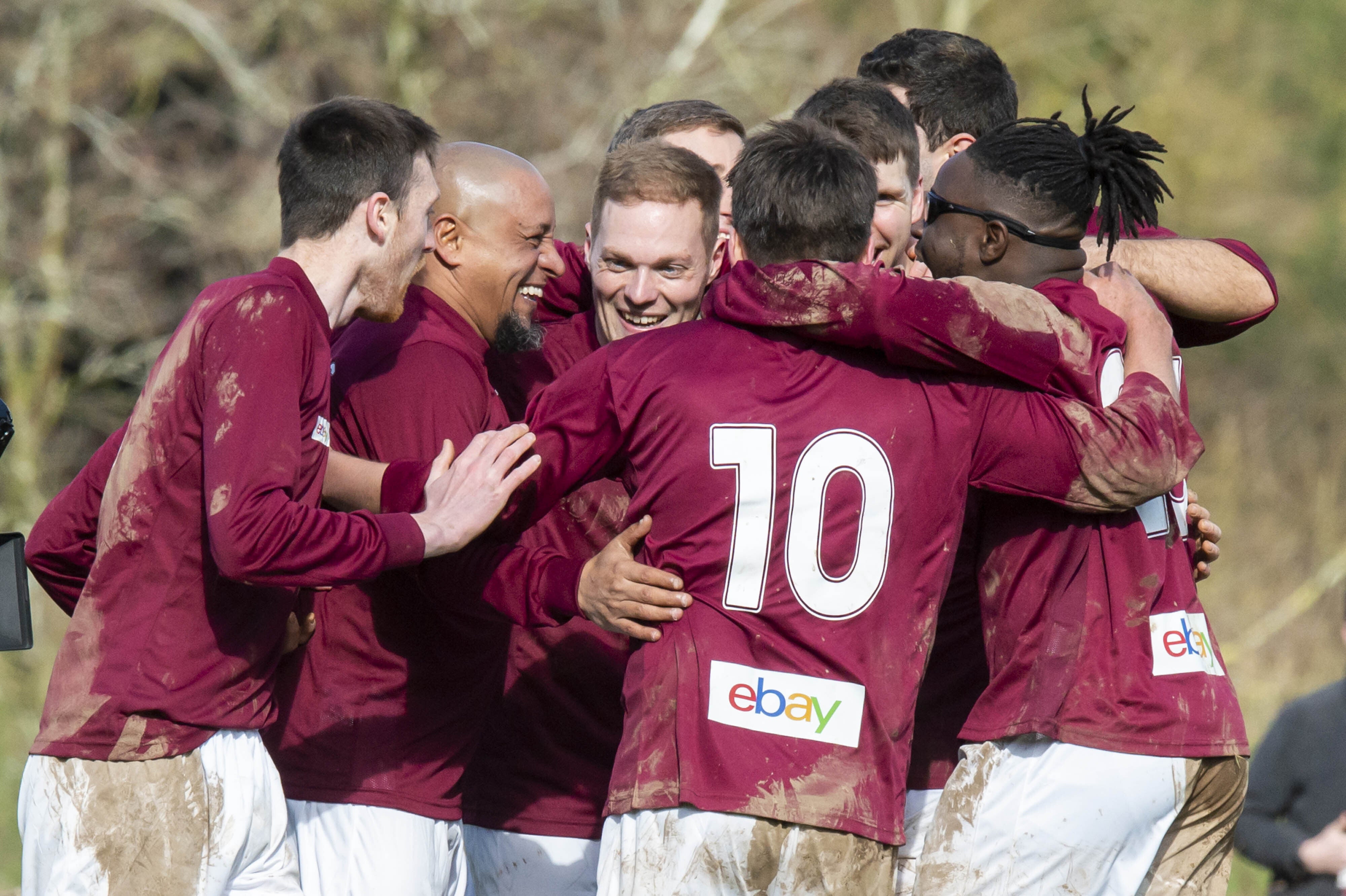 Former Real Madrid left-back Roberto Carlos is mobbed by his new Bull in the Barne United team-mates (Anthony Devlin/PA)