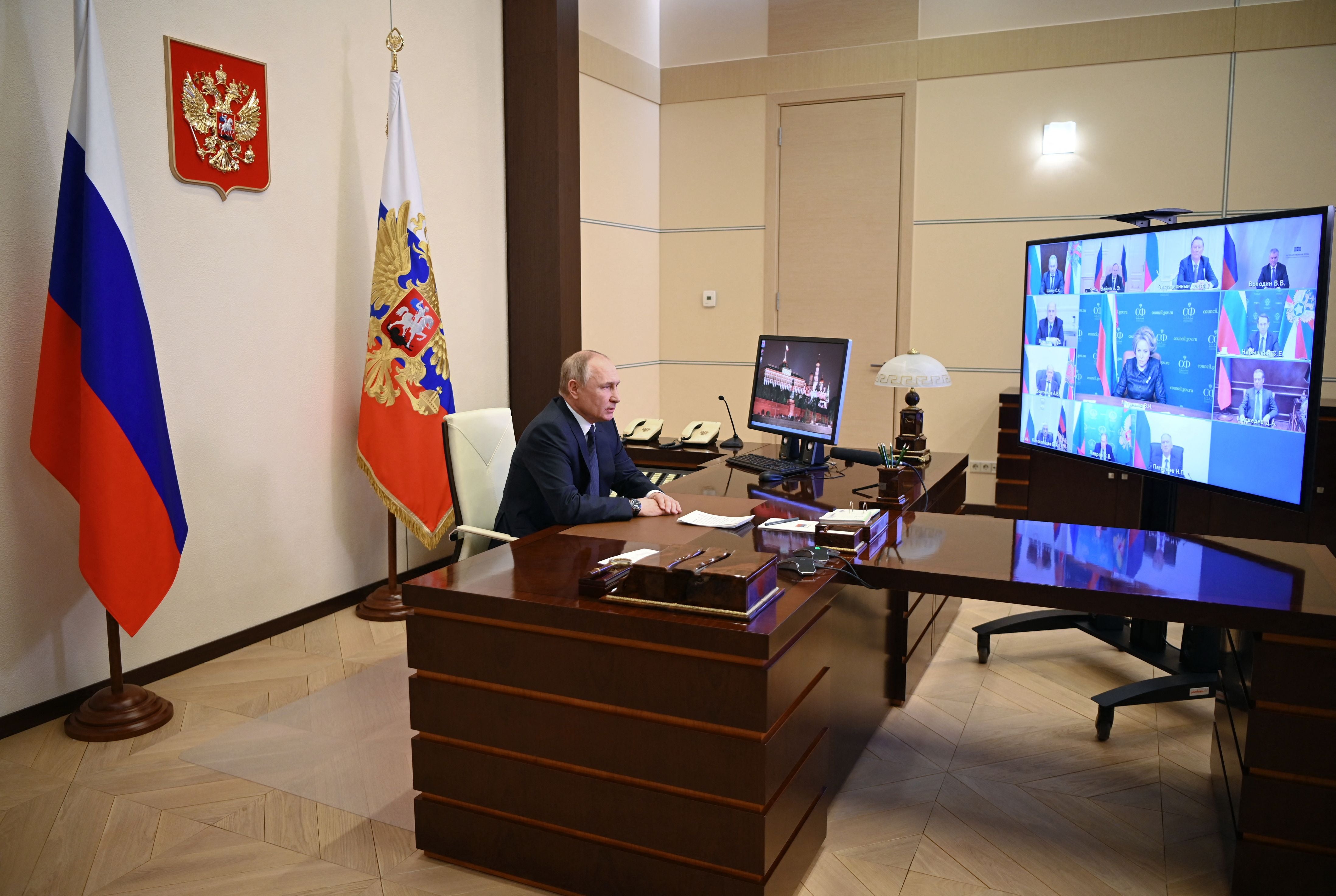 Russian president Vladimir Putin chairs a meeting with members of the Security Council at the state residence outside Moscow