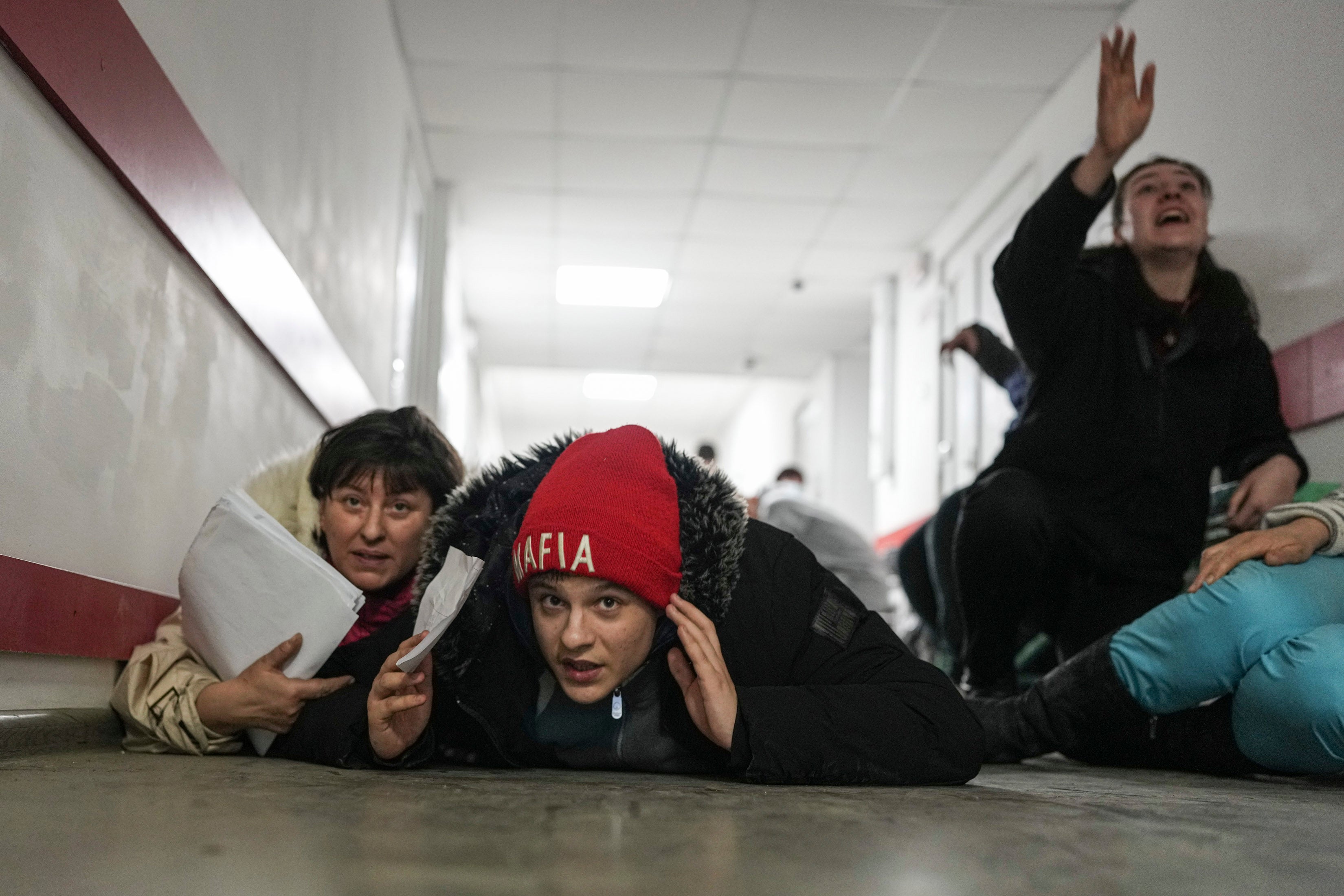 People lie on the floor of a hospital in Mariupol during shelling by Russian forces on Friday