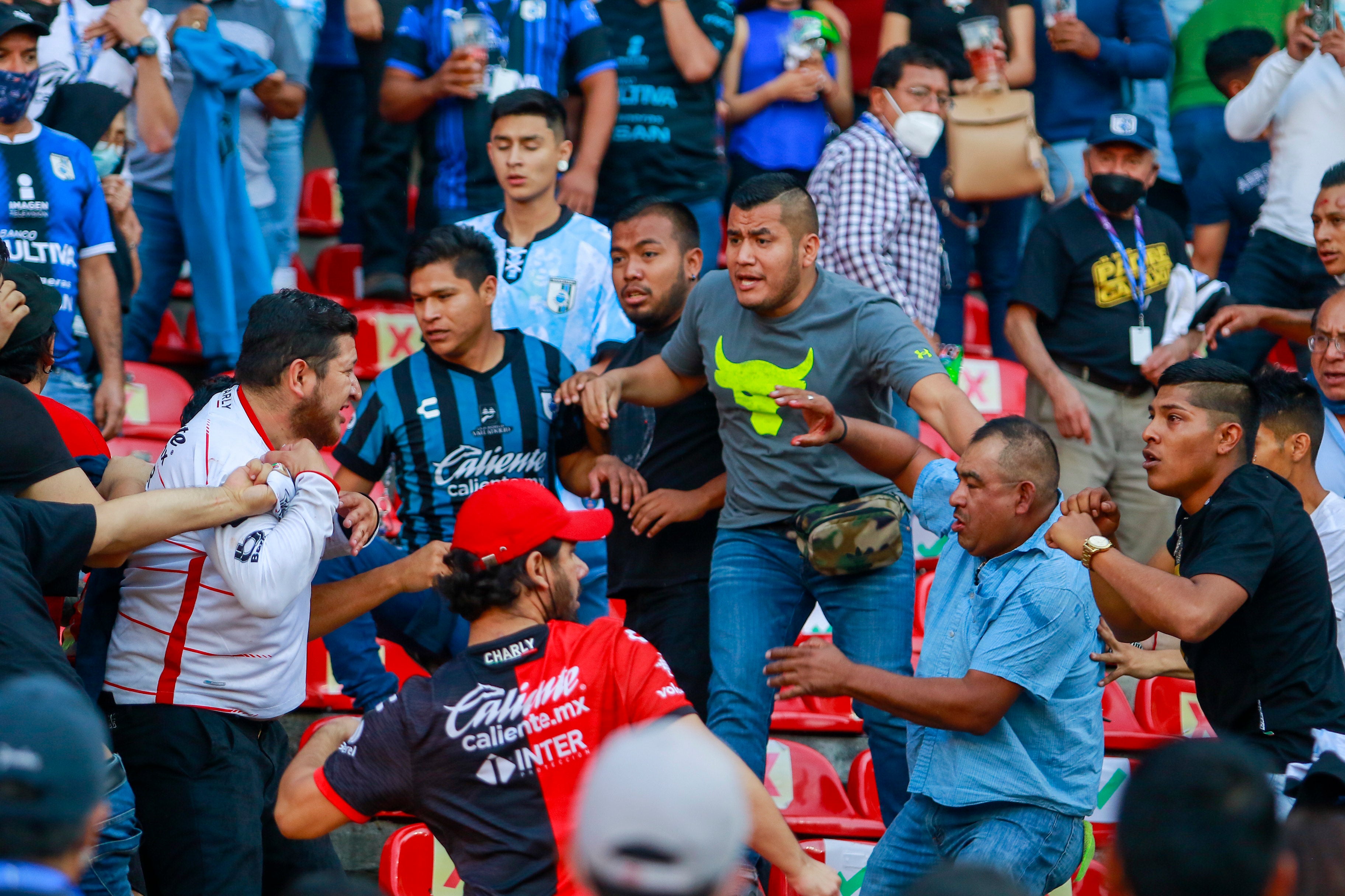 Fans clashed in the stands and on the pitch (Eduardo Gomez Reyna/AP)