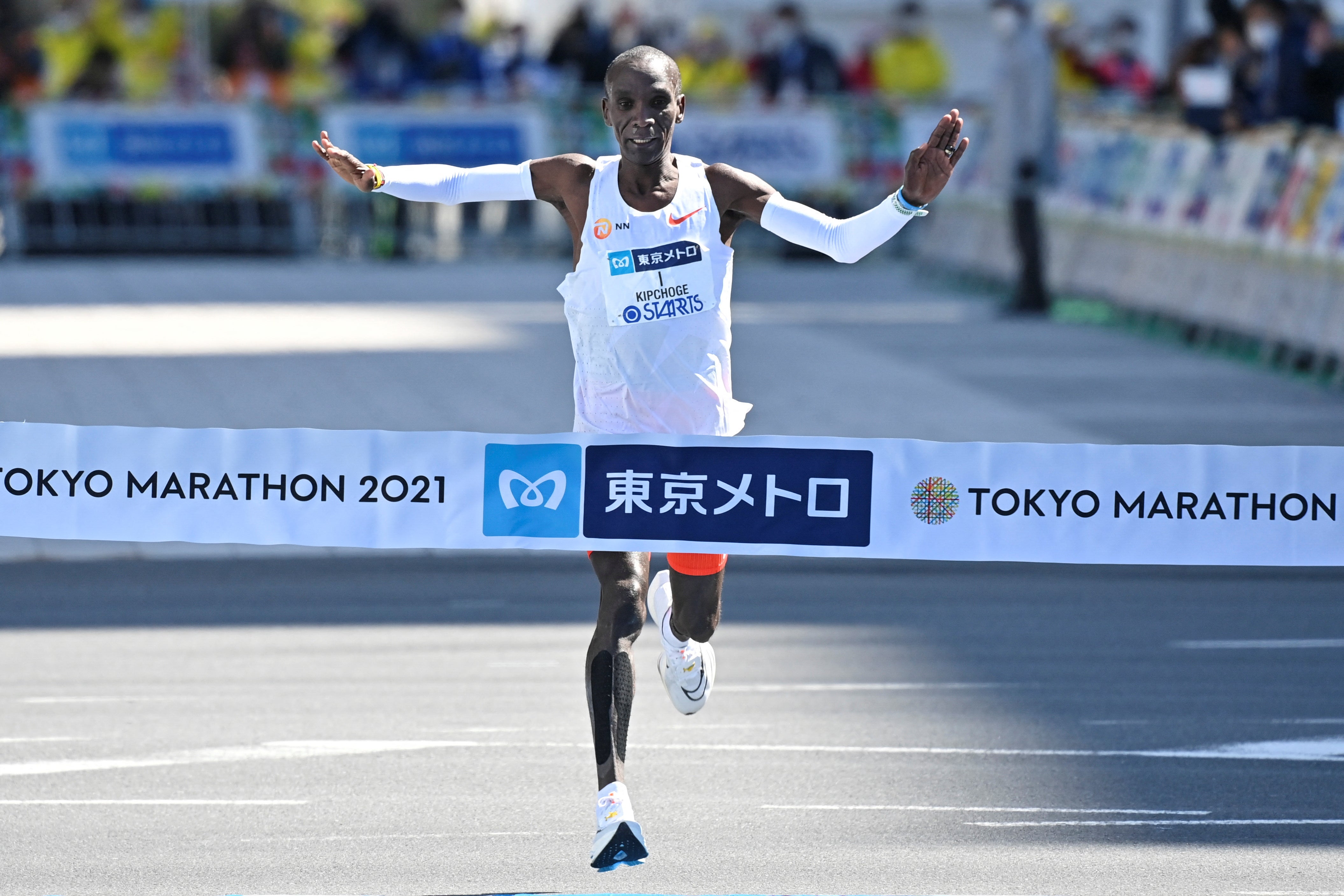 Kenyan Eliud Kipchoge crosses the finish line to win the men's category in the Tokyo Marathon