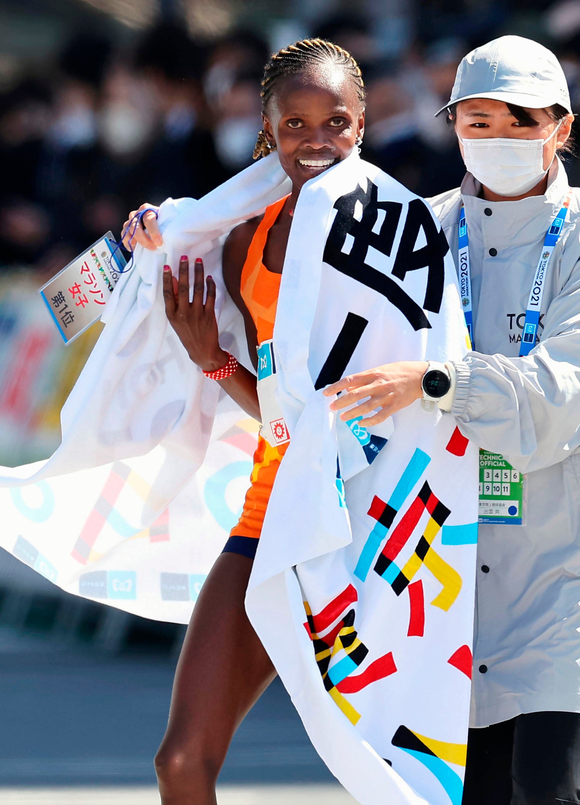 Brigid Kosgei, of Kenya, walks after crossing the finish line