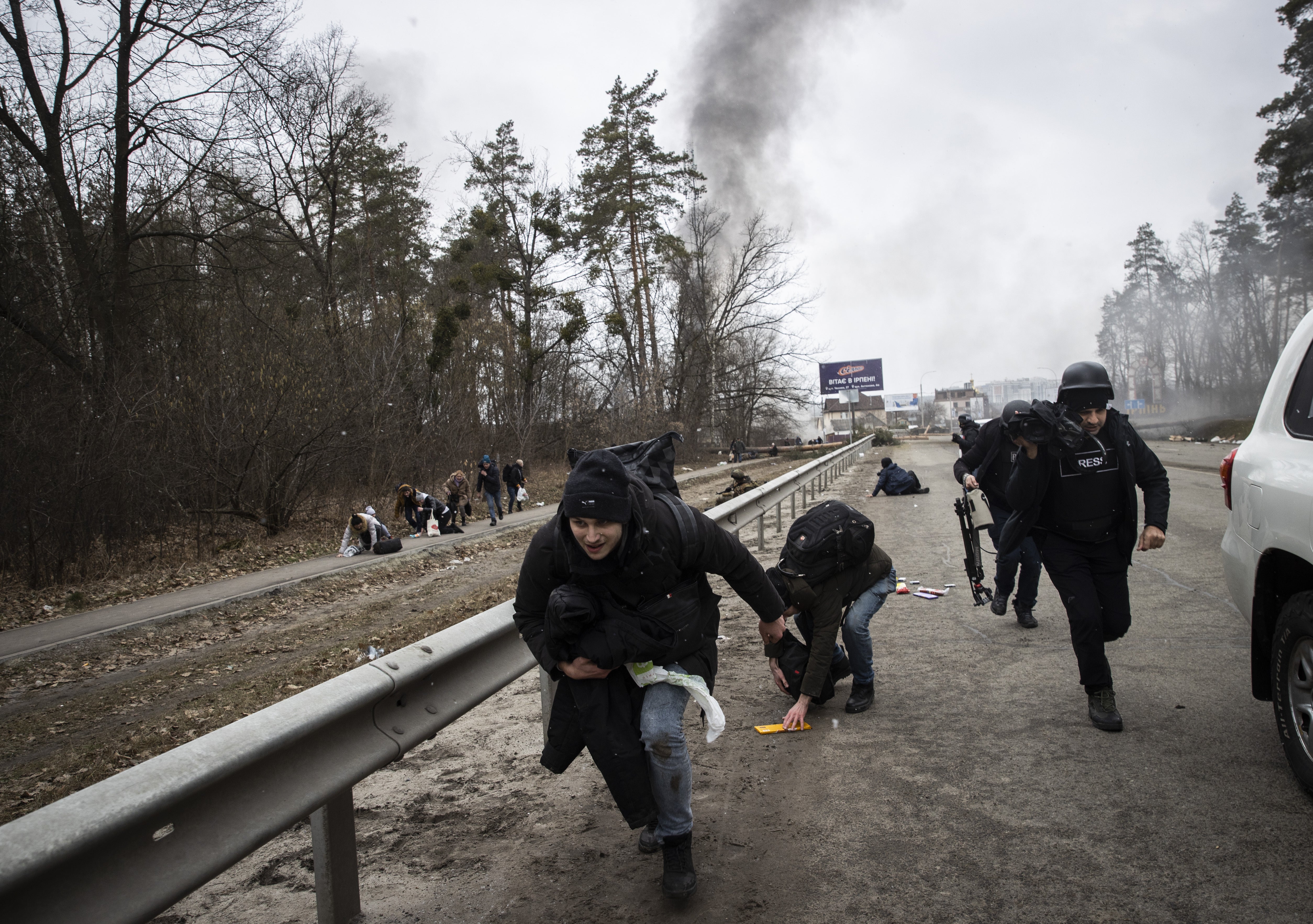 Civilians flee Irpin under fire last March, not long after the war started