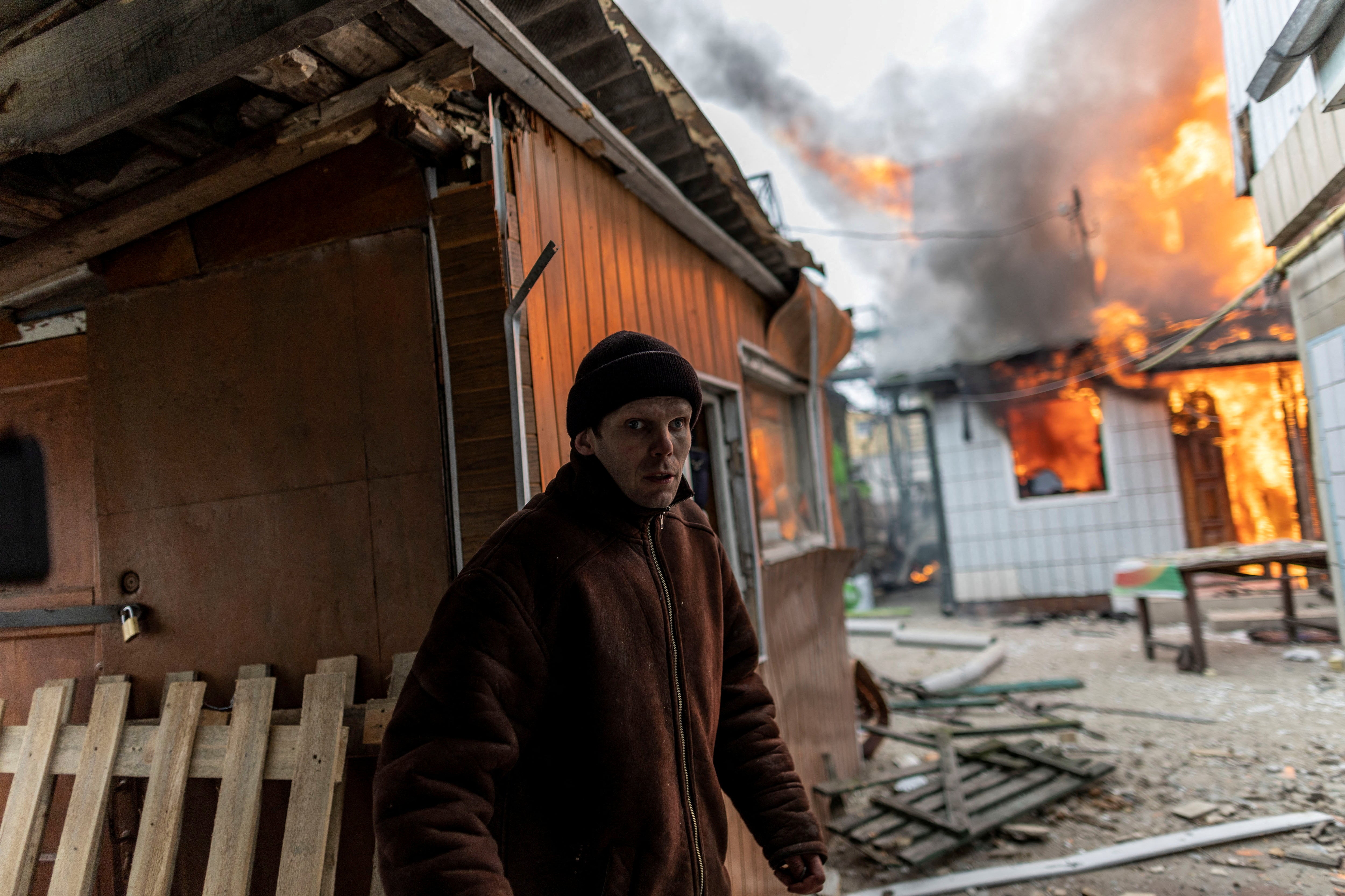 A house burns after heavy shelling on the only escape route used by locals to leave Irpin