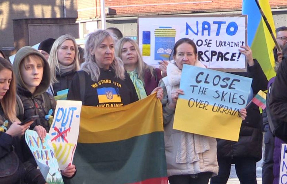 People take part in a rally outside Custom House Square in Belfast to denounce the Russian invasion of Ukraine (PA)