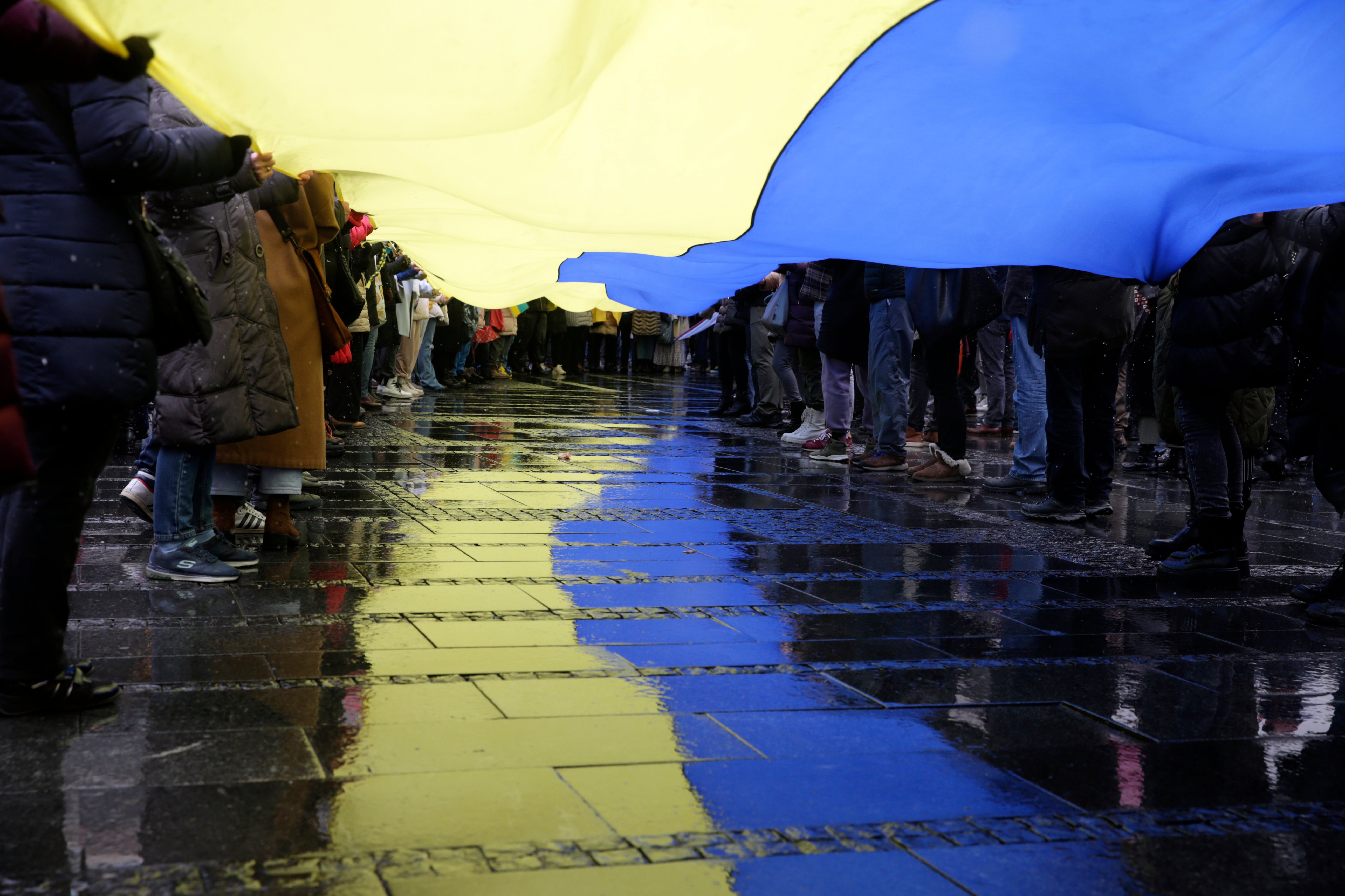 Protesters carry a huge Ukrainian flag during a rally against Russia's military operation in Ukraine, in Belgrade, Serbia, on Sunday