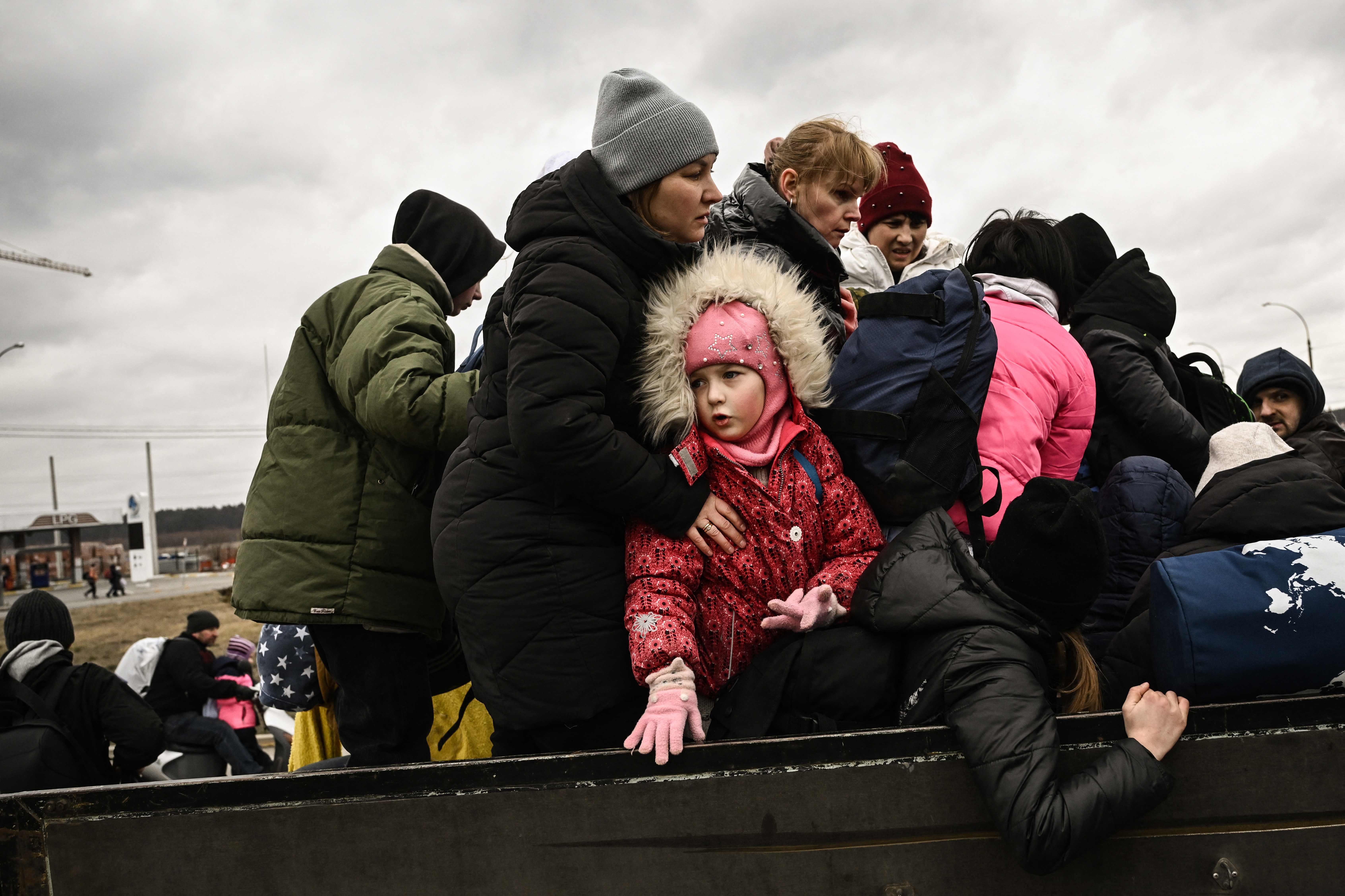 A child looks on a residents evacuate the city of Irpin, northwest of Kyiv, during heavy shelling and bombing on 5 March.