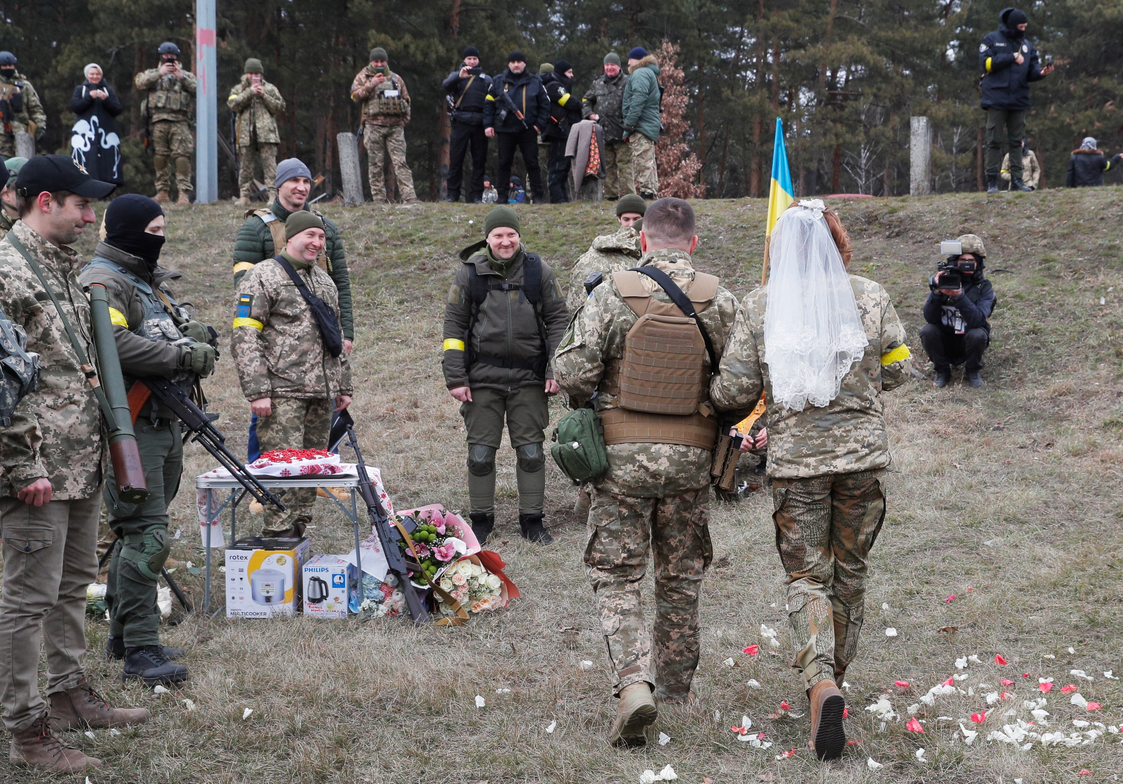 In as traditional a ceremony as was possible in the circumstances, the bride wore a veil over her military clothes, incense was lit and the couple were showered with flower petals.