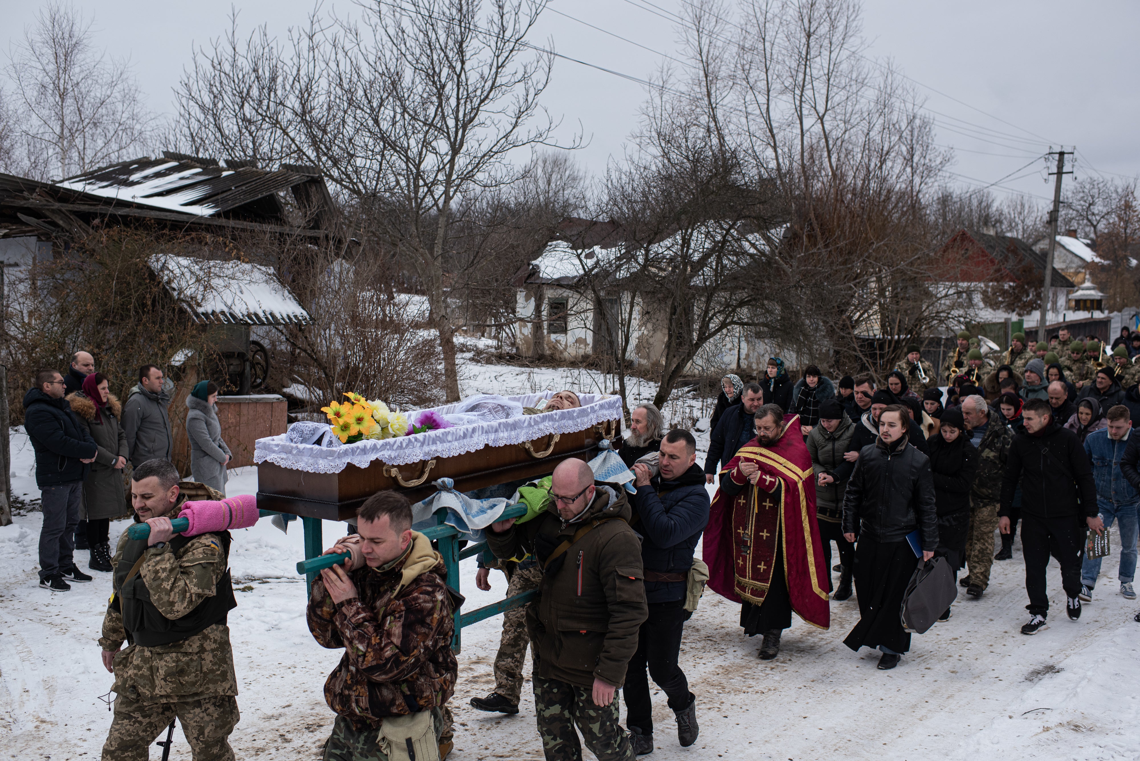 Soldiers carry the body of their comrade Denys Hrynchuk from his family's house to the church in Chernivtsi region, Ukraine.