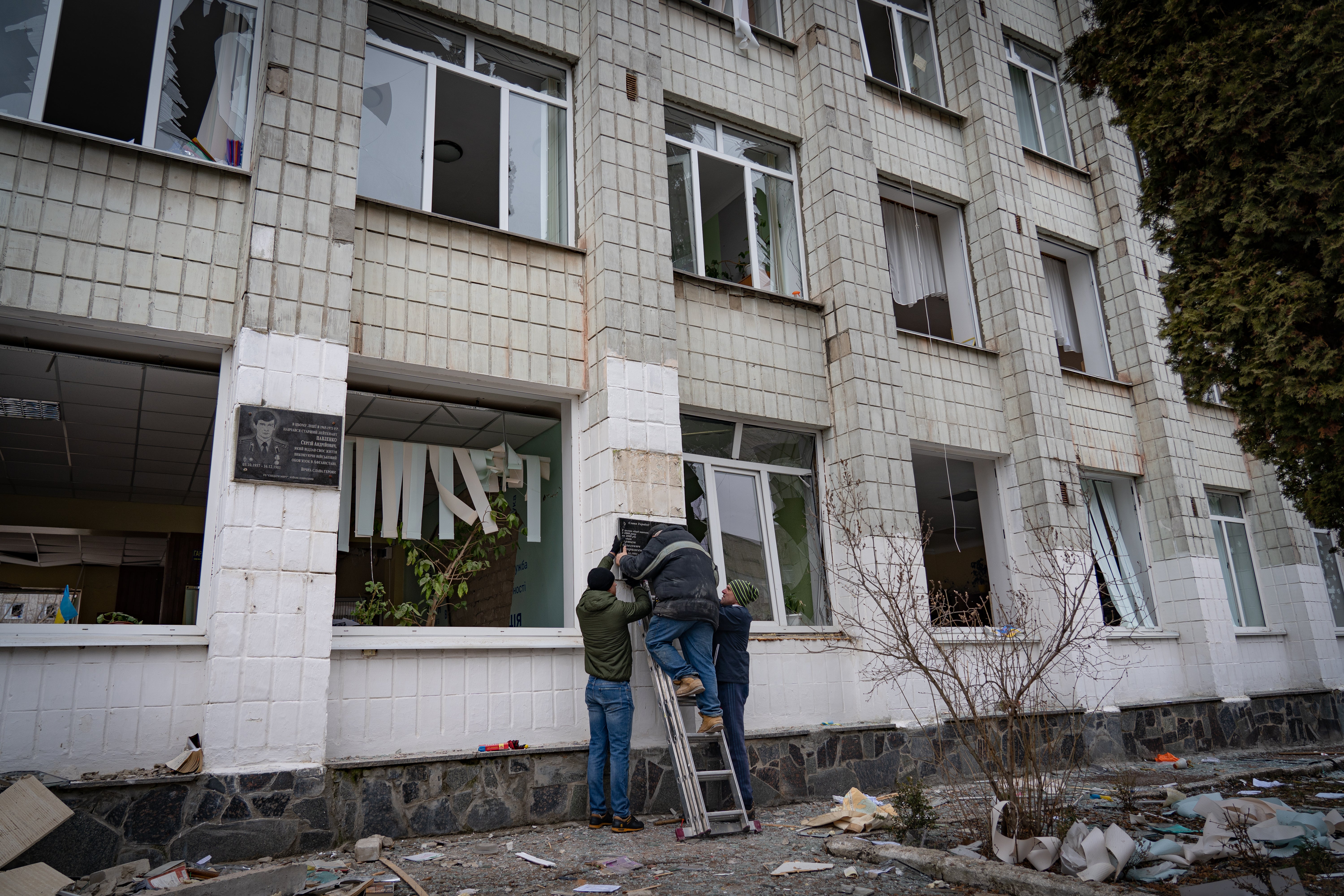 Workers start repairs on the school after it was hit by a Russian missile