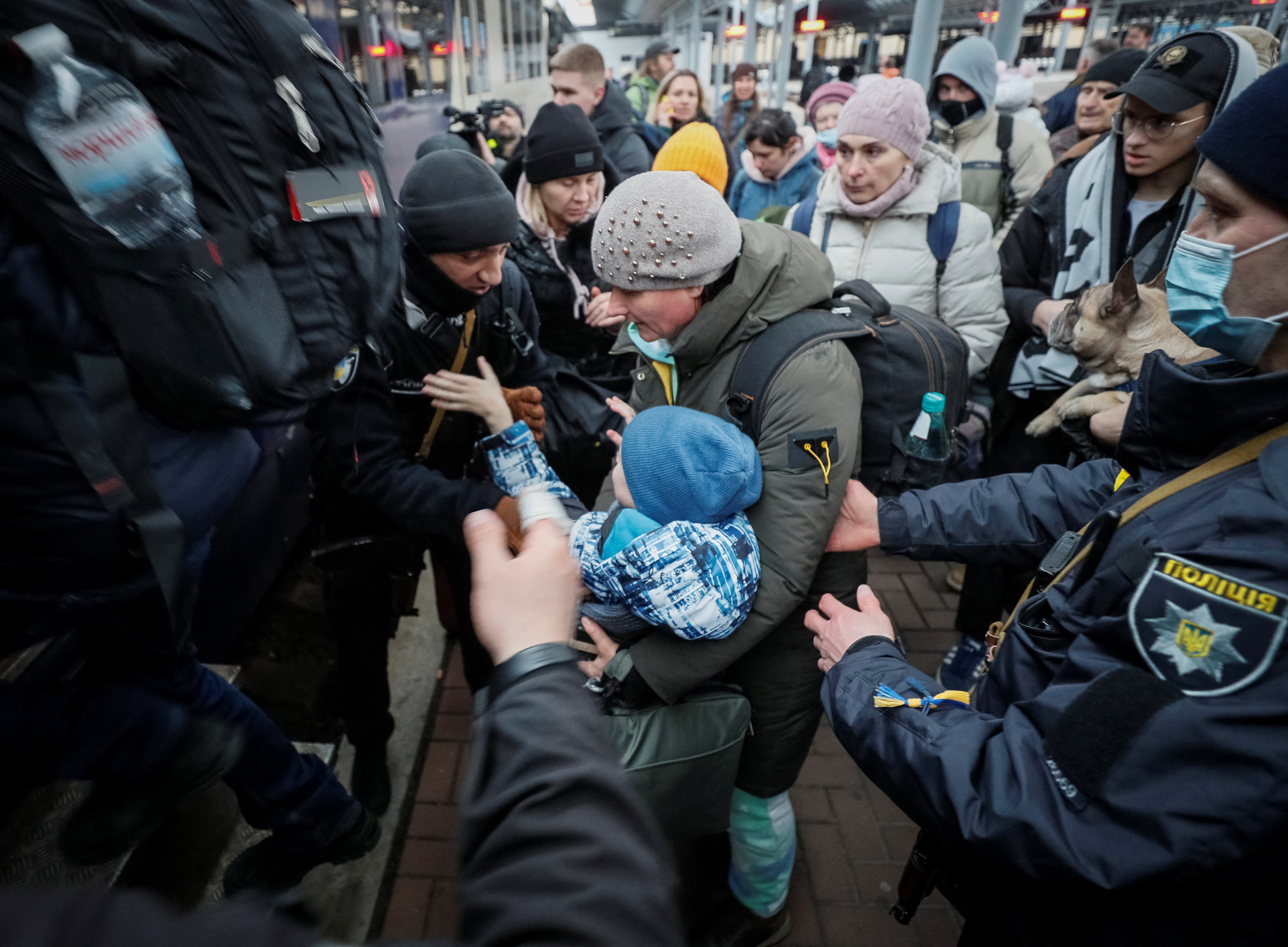 People with children from Okhmatdyt Children’s Hospital in Kyiv board an evacuation train to Lviv