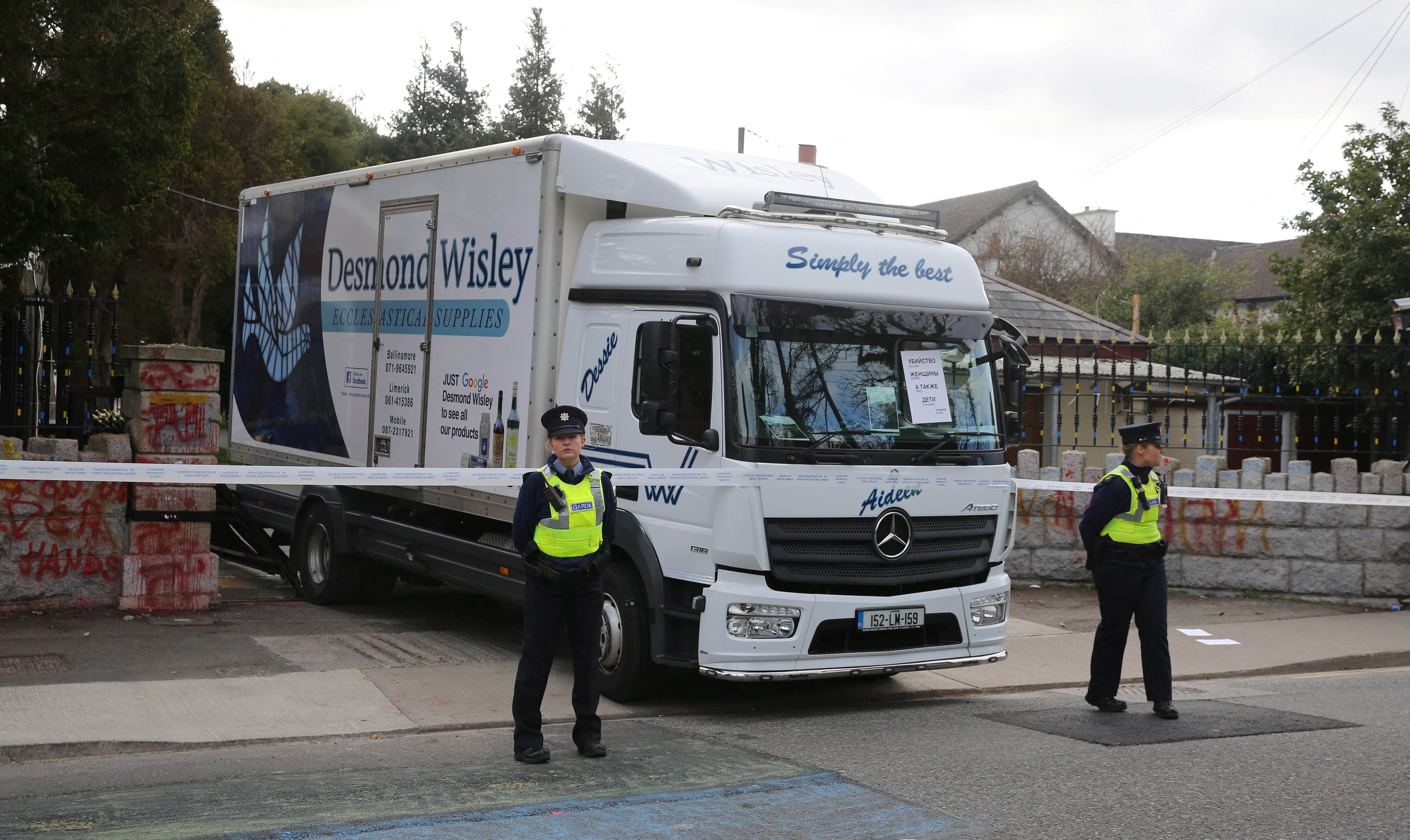 Irish police stand guard at the Russian Embassy following an incident where a truck reversed through the entrance gate