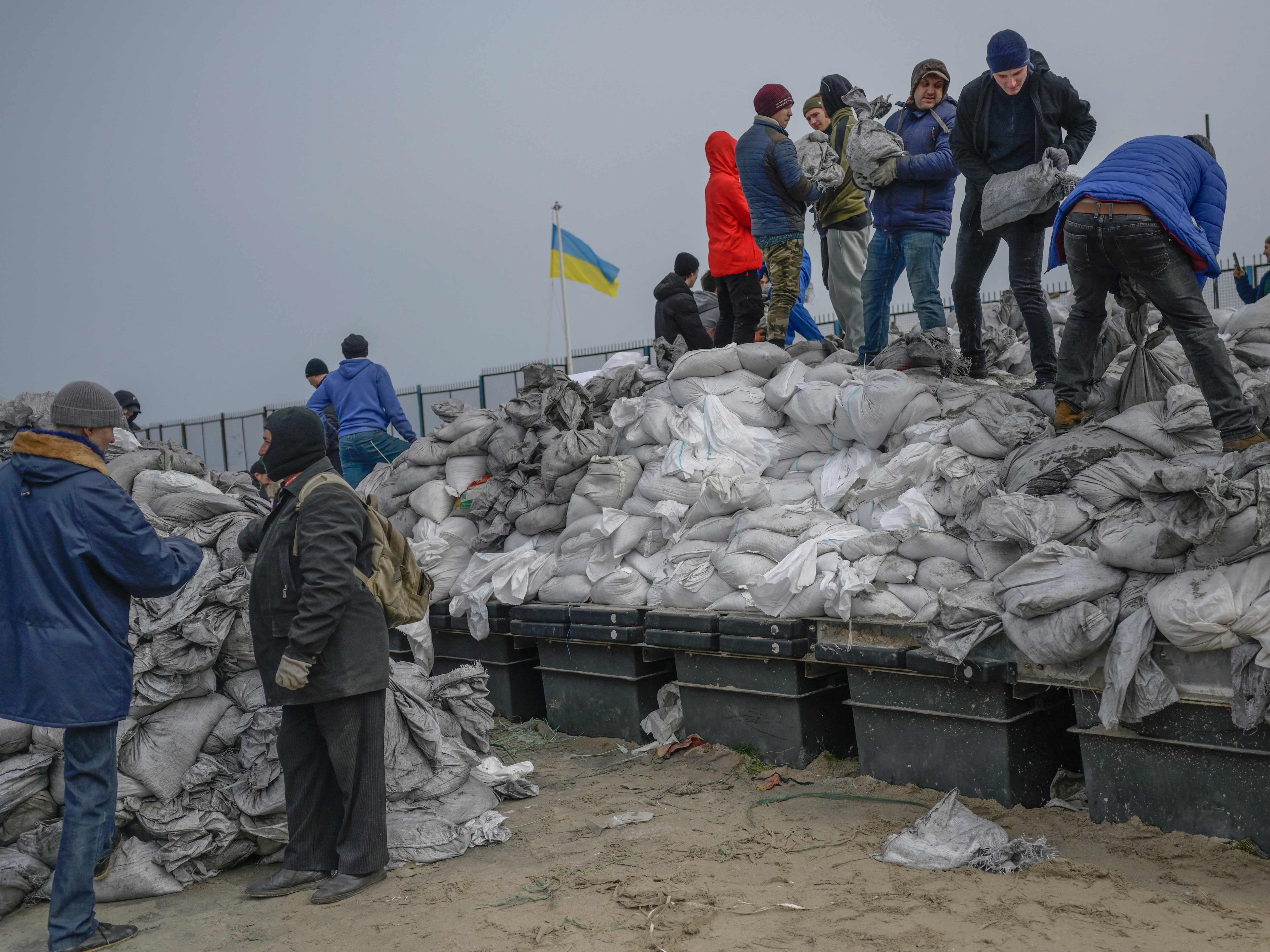 Citizens fill bags with sand for frontlines along the beach of the Black Sea city of Odessa, in southern Ukraine, on 7 March 2022