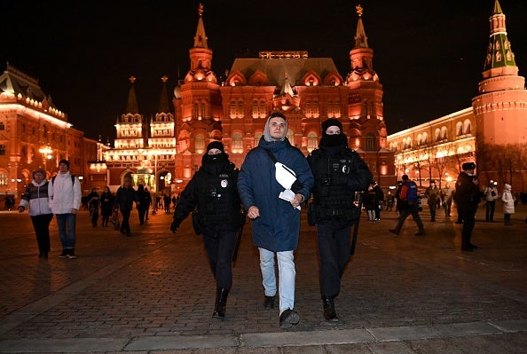 Riot police officers detain a man during a protest against Russia's invasion of Ukraine in central Moscow