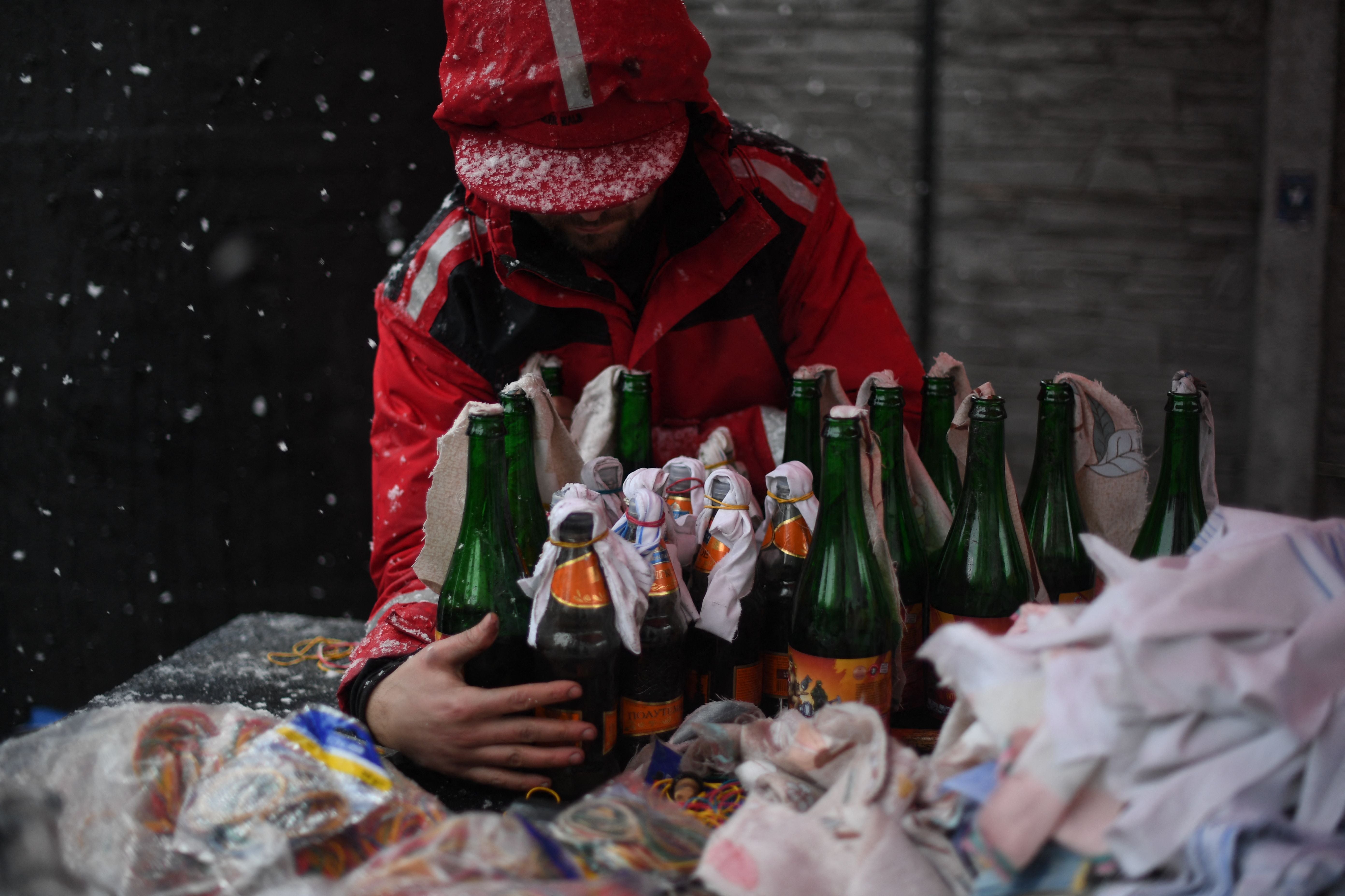 A volunteer prepares Molotov cocktails at the Pravda – (Truth) brewery in Lviv, 27 February 2022