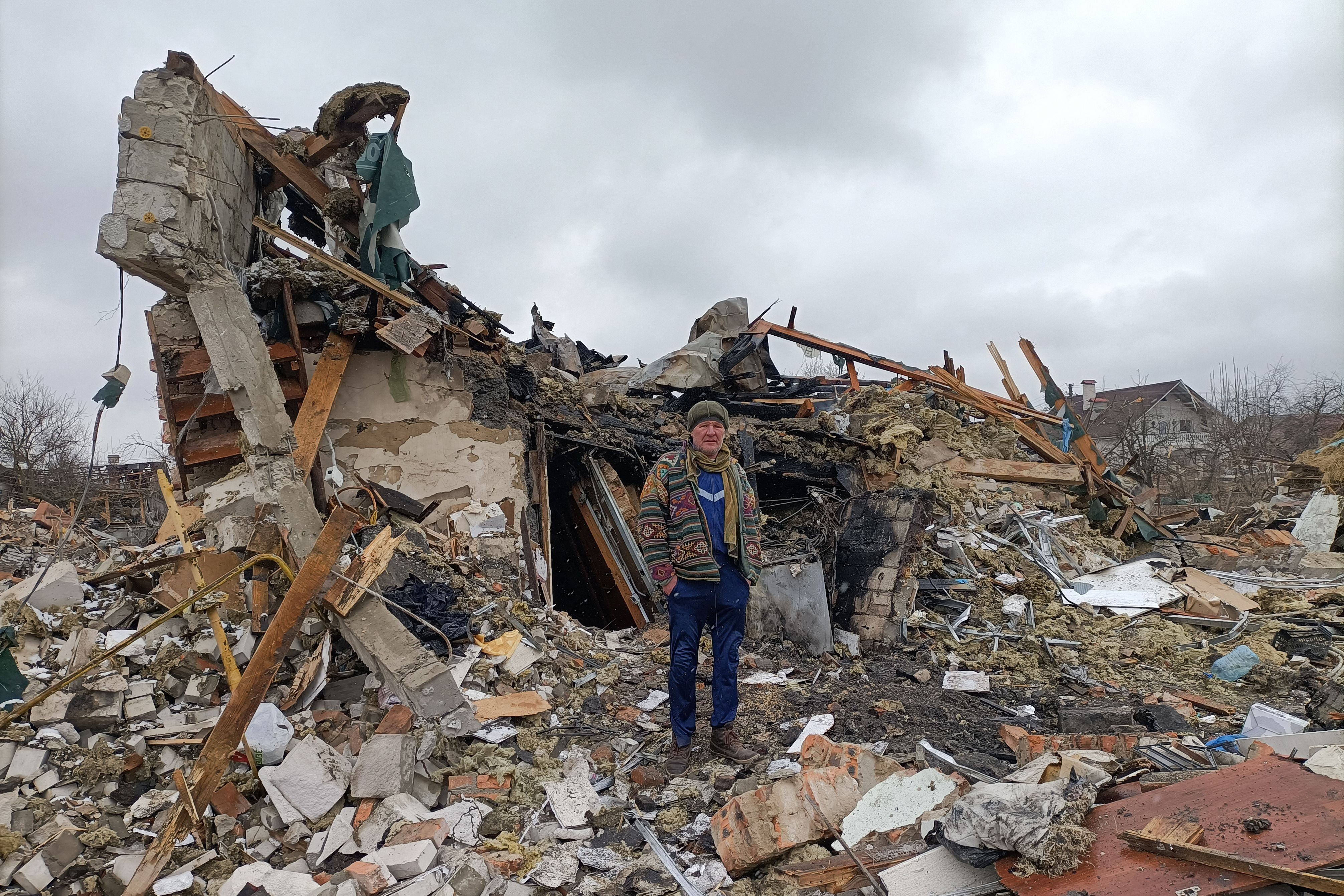 A Ukrainian man stands in the rubble in Zhytomyr on 2 March 2022, following a Russian bombing the day before.