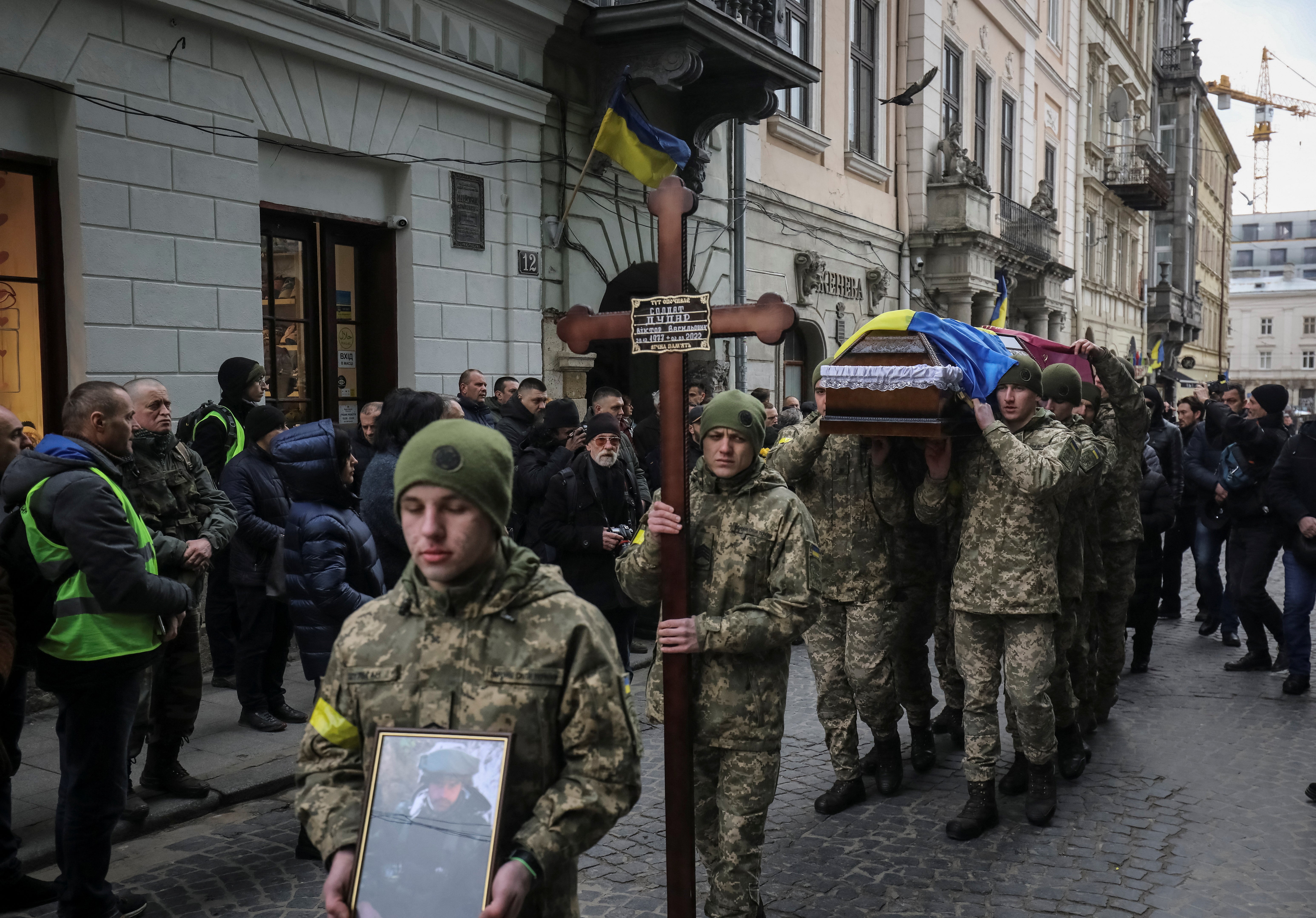 Service members carry coffins of Viktor Dudar and Ivan Koverznev, Ukrainian servicemen killed earlier this month