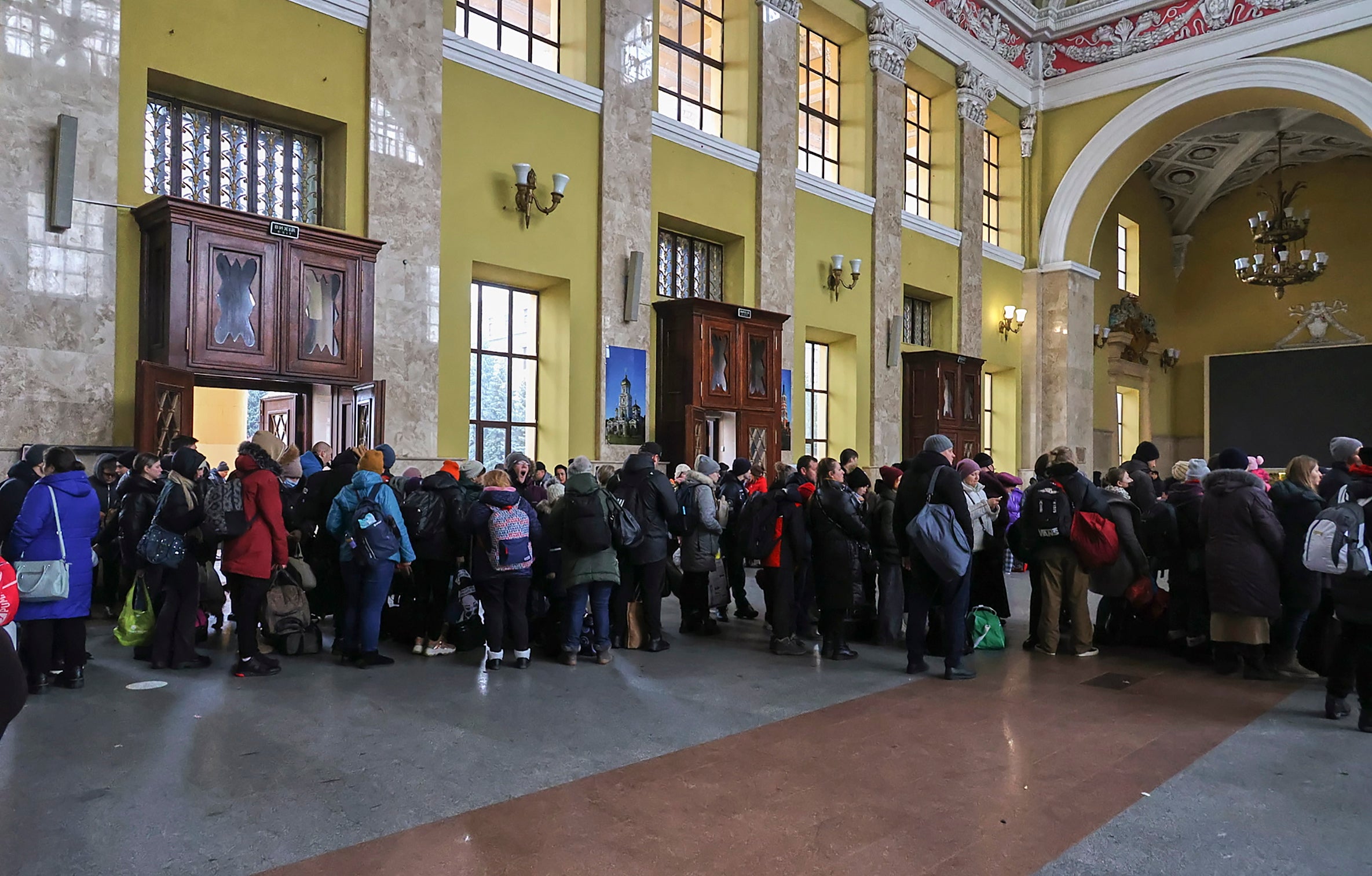 People wait for an evacuation train at a railway station in Kharkiv on 3 March