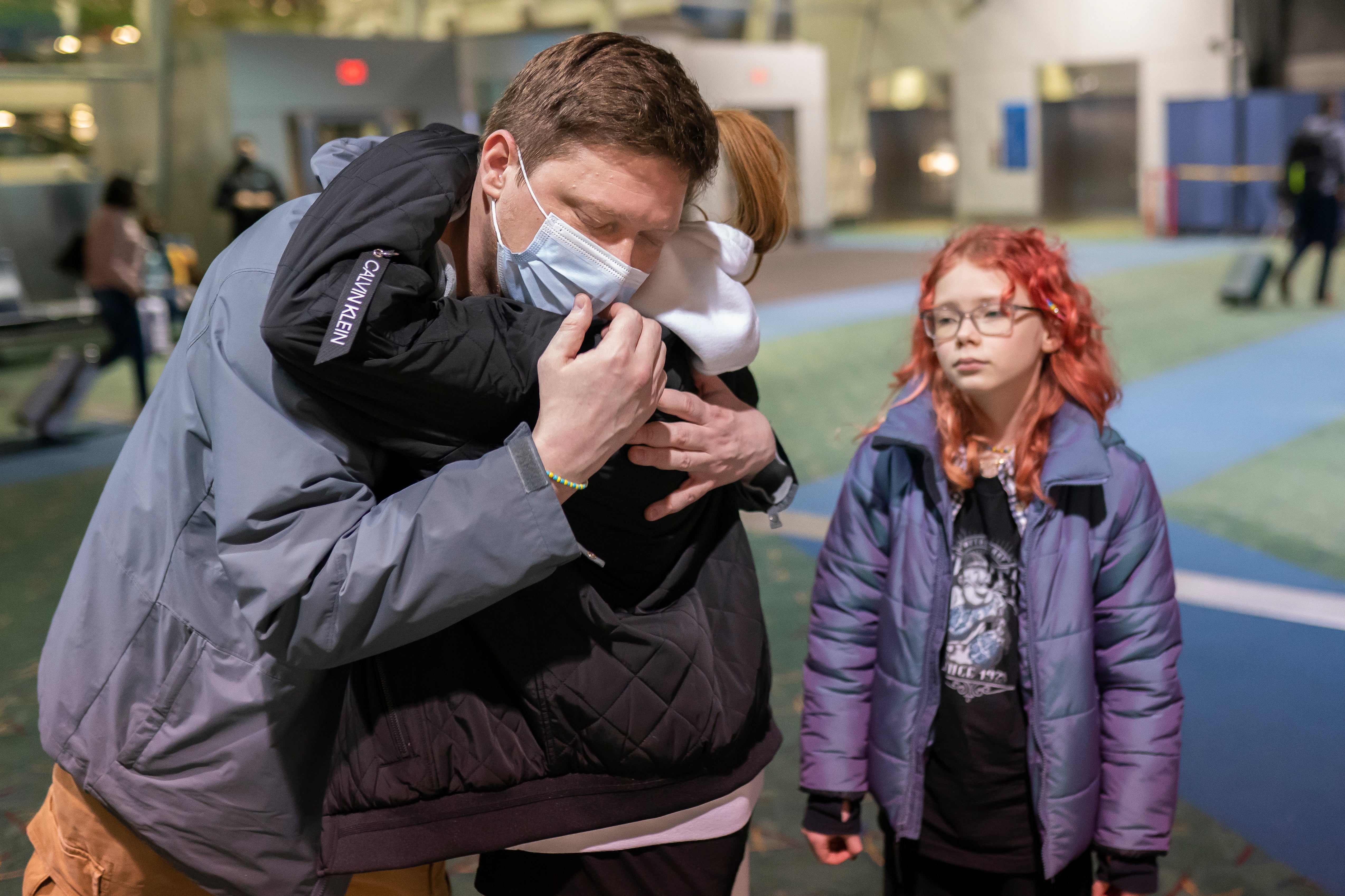 Sergey Korenev says goodbye to his two daughters at Portland International Airport as he heads to Ukraine