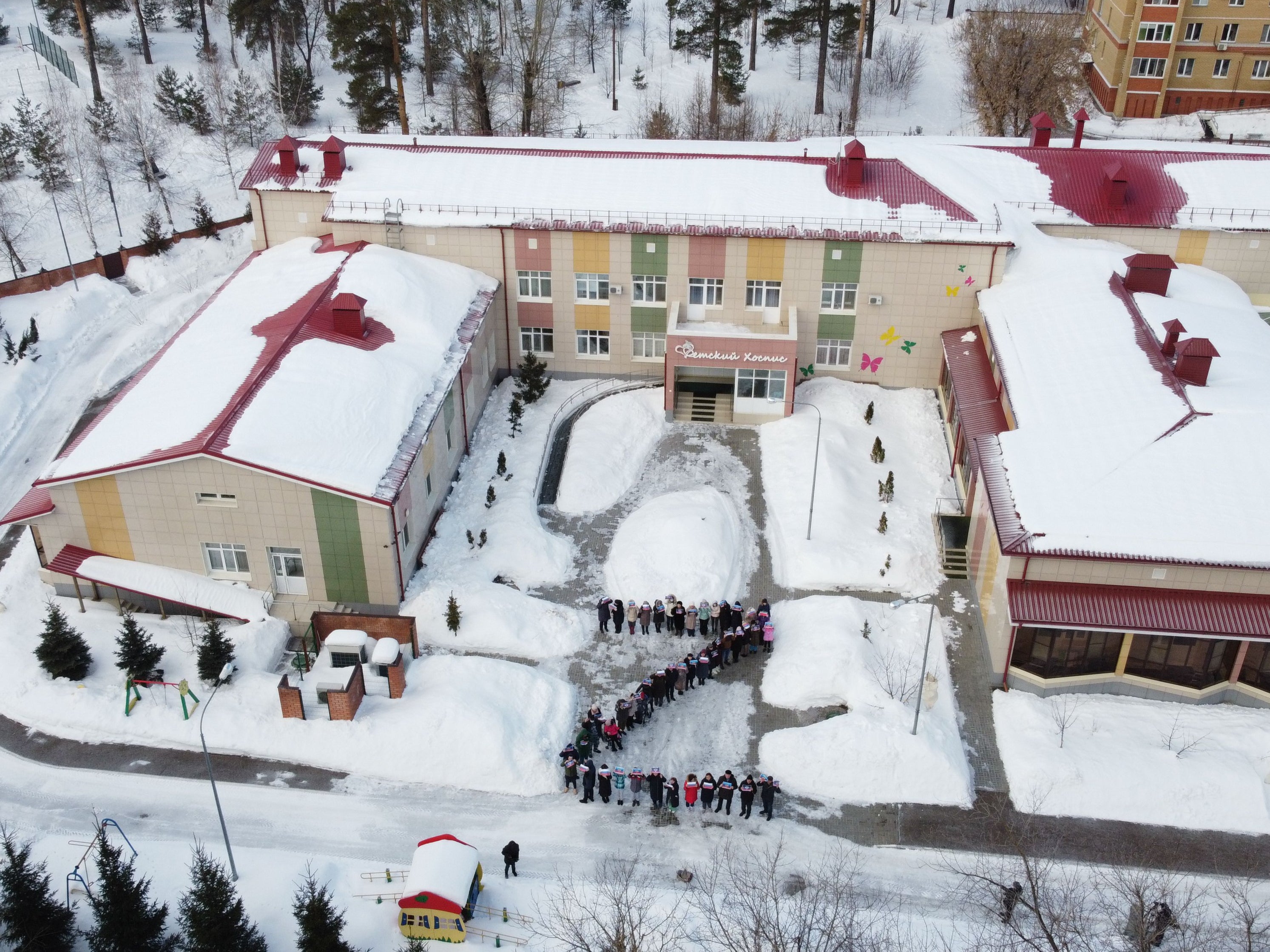 Terminally ill children in Kazan, Russia, line up outside a cancer hospice in the shape of Z