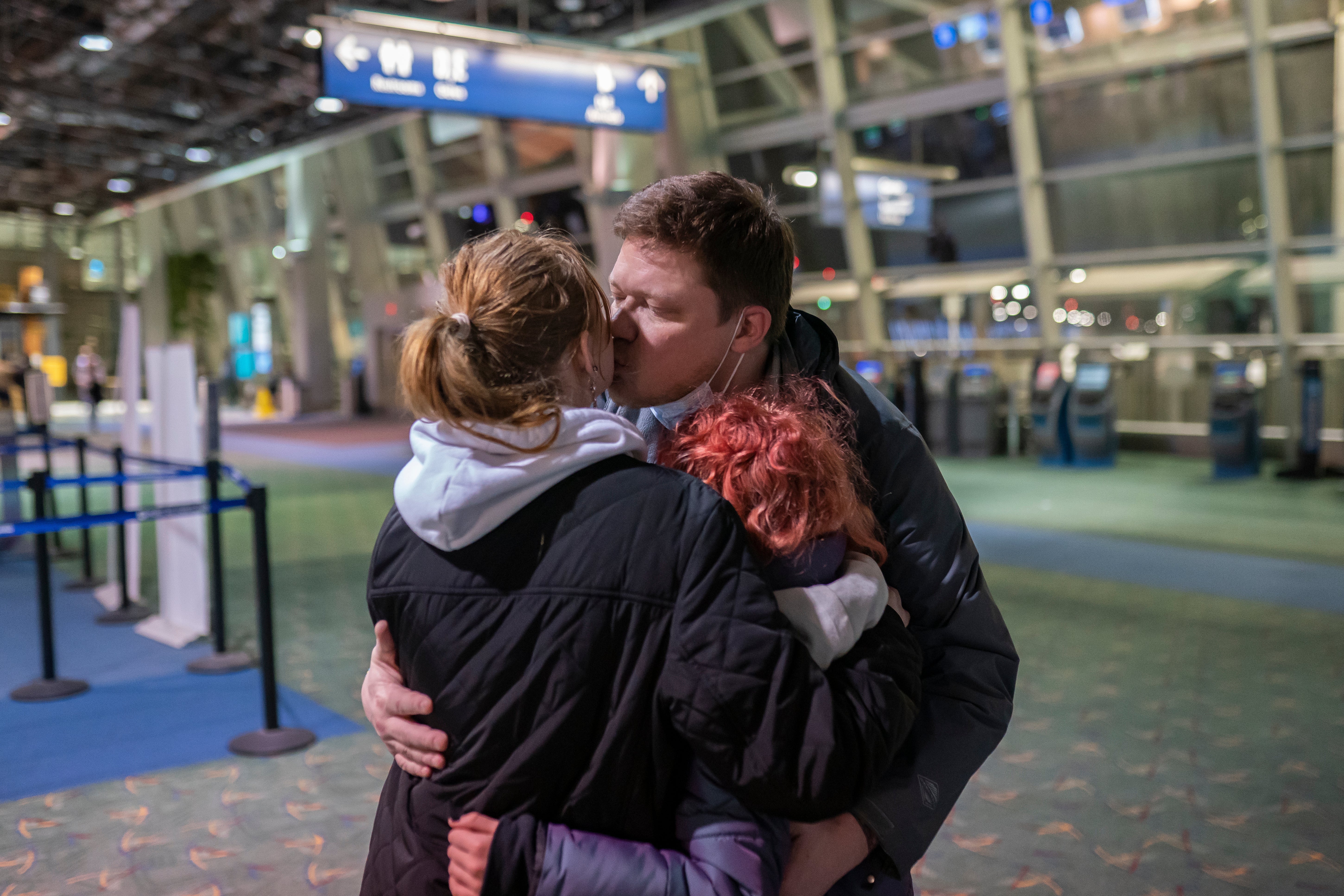 Sergey Korenev says goodbye to his two daughters at the airport