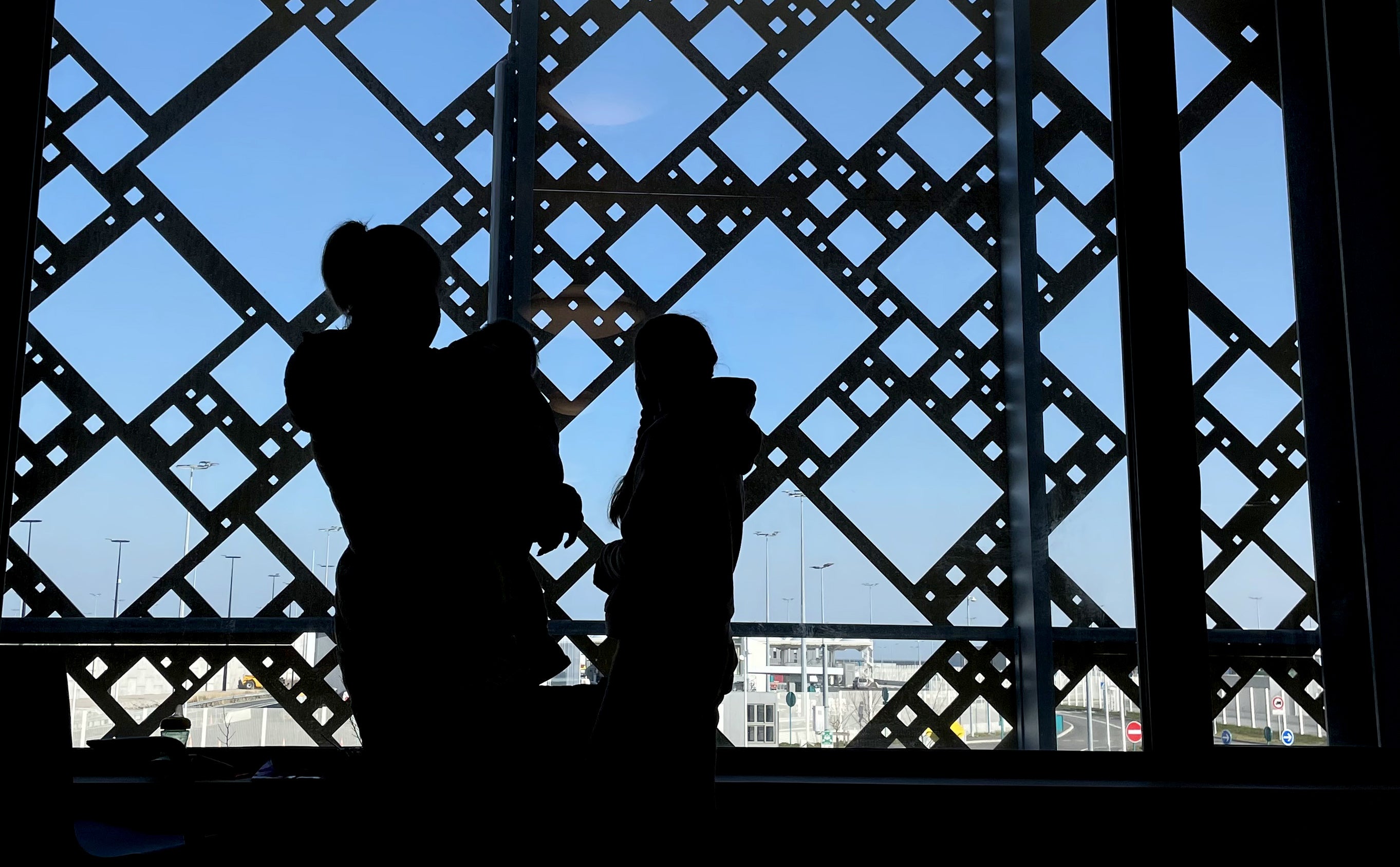 Members of a Ukrainian family wait for paperwork to be completed at the ferry terminal in Calais, France, after they fled Ukraine (Gareth Fuller/PA)