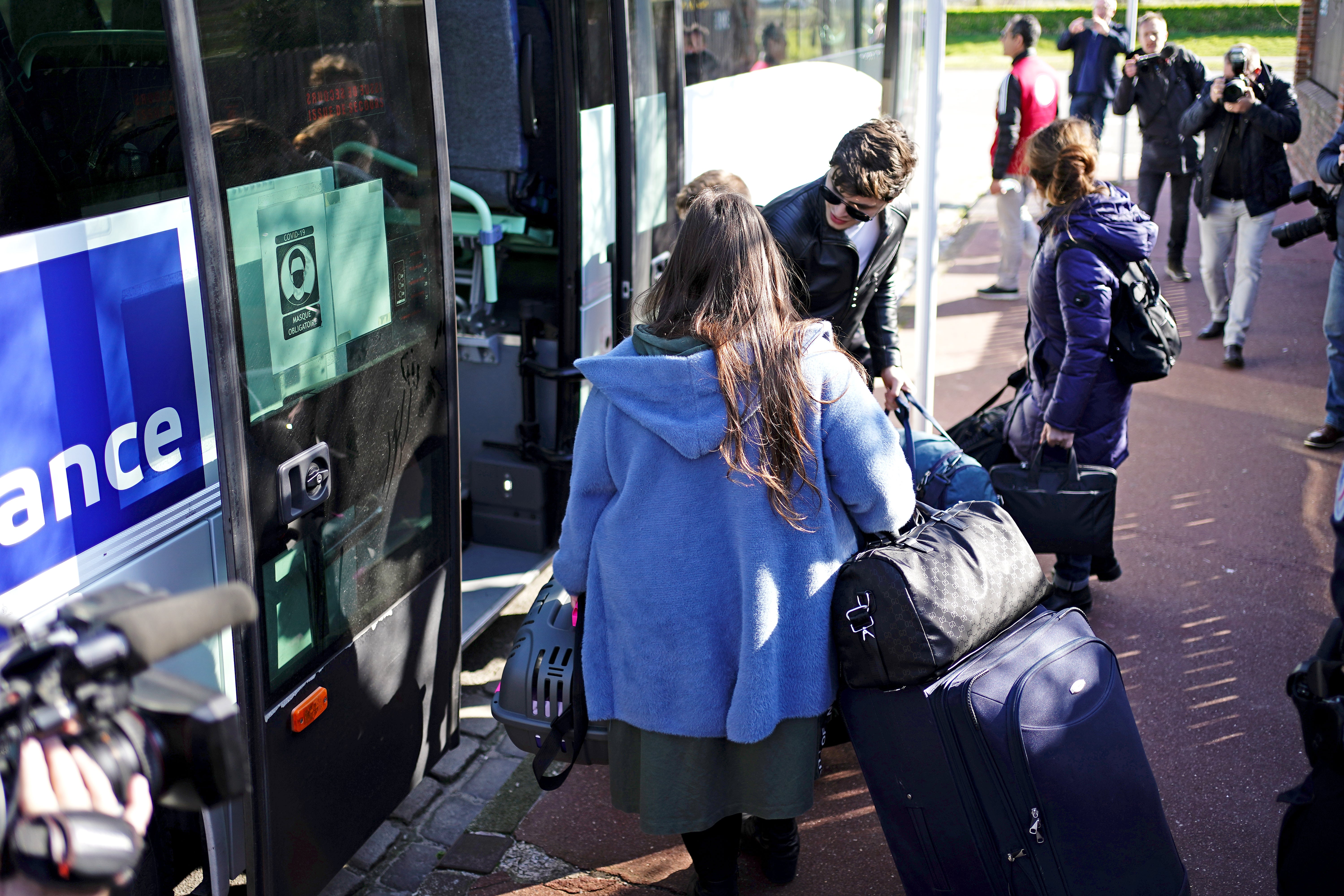 Ukrainian refugees load their belongings on to a bus before it departs from the Centre Europeen de Sejours youth hostel in Calais, where they have been accommodated before onward travel to other areas (Aaron Chown/PA)