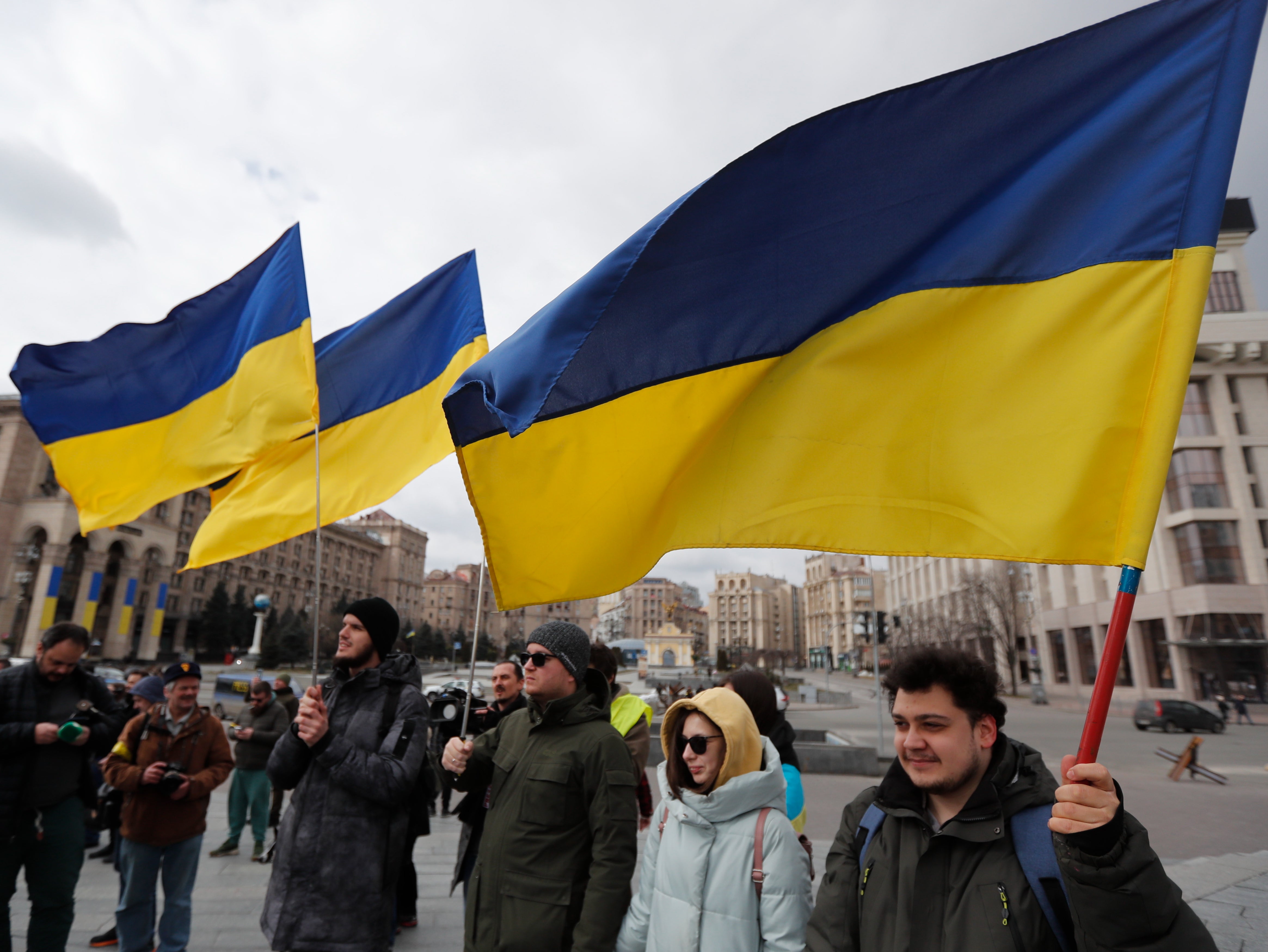 People hold Ukrainian flags as members of the Kyiv-Classic symphonic orchestra perform