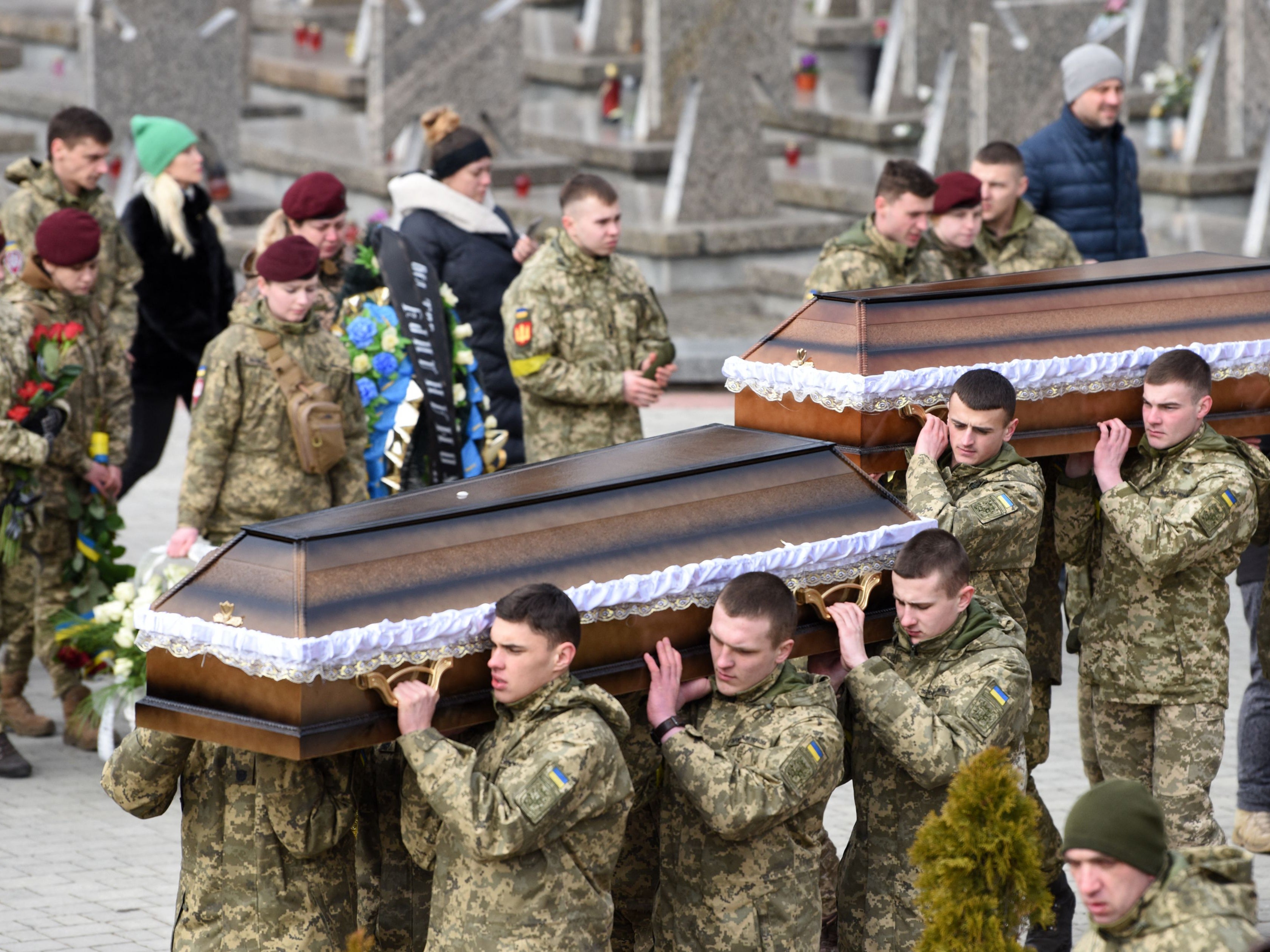 Servicemen carry the coffins of Ukrainian soldiers killed in fighting