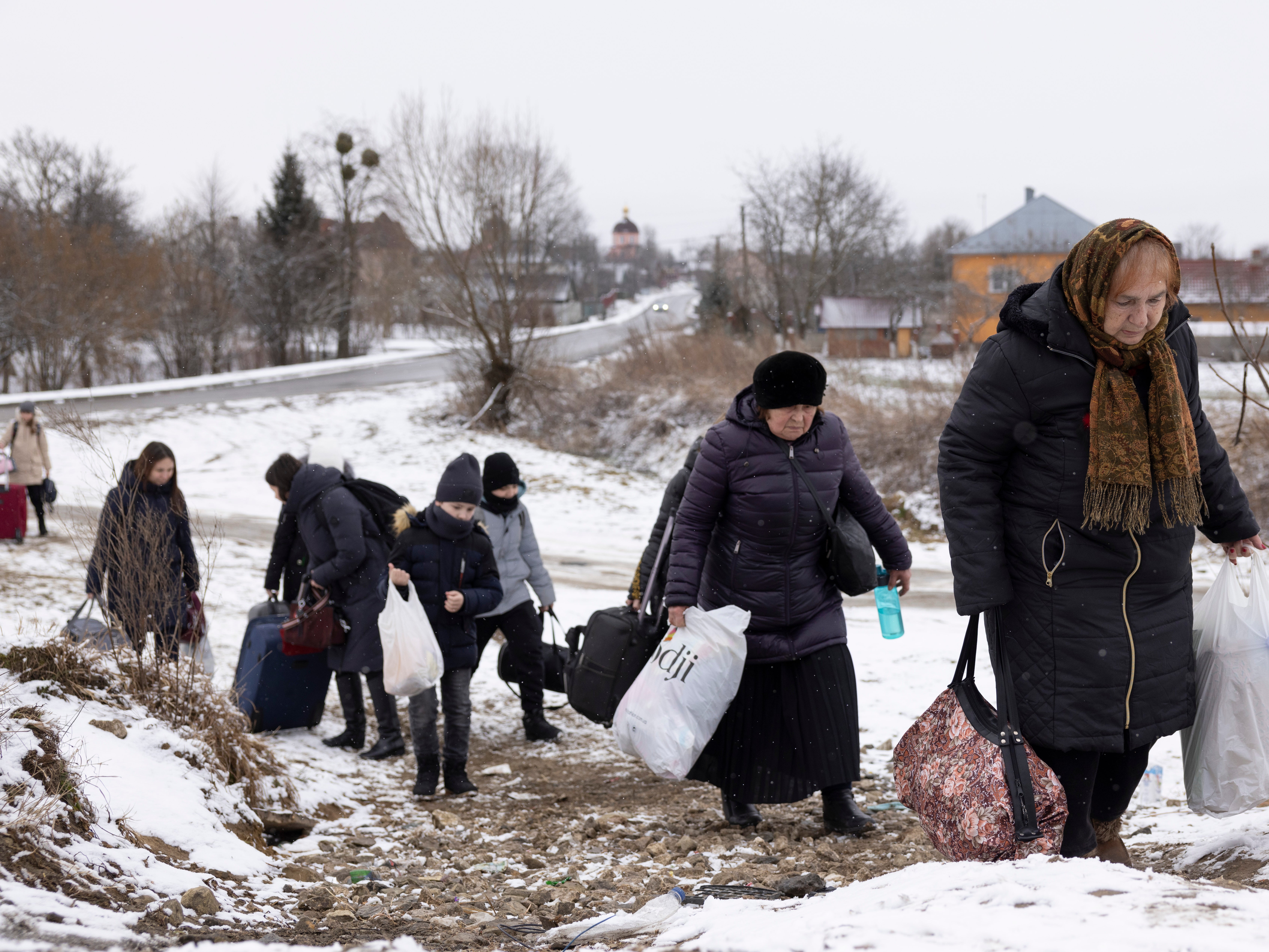 Refugees make their way to the Krakovets border crossing with Poland