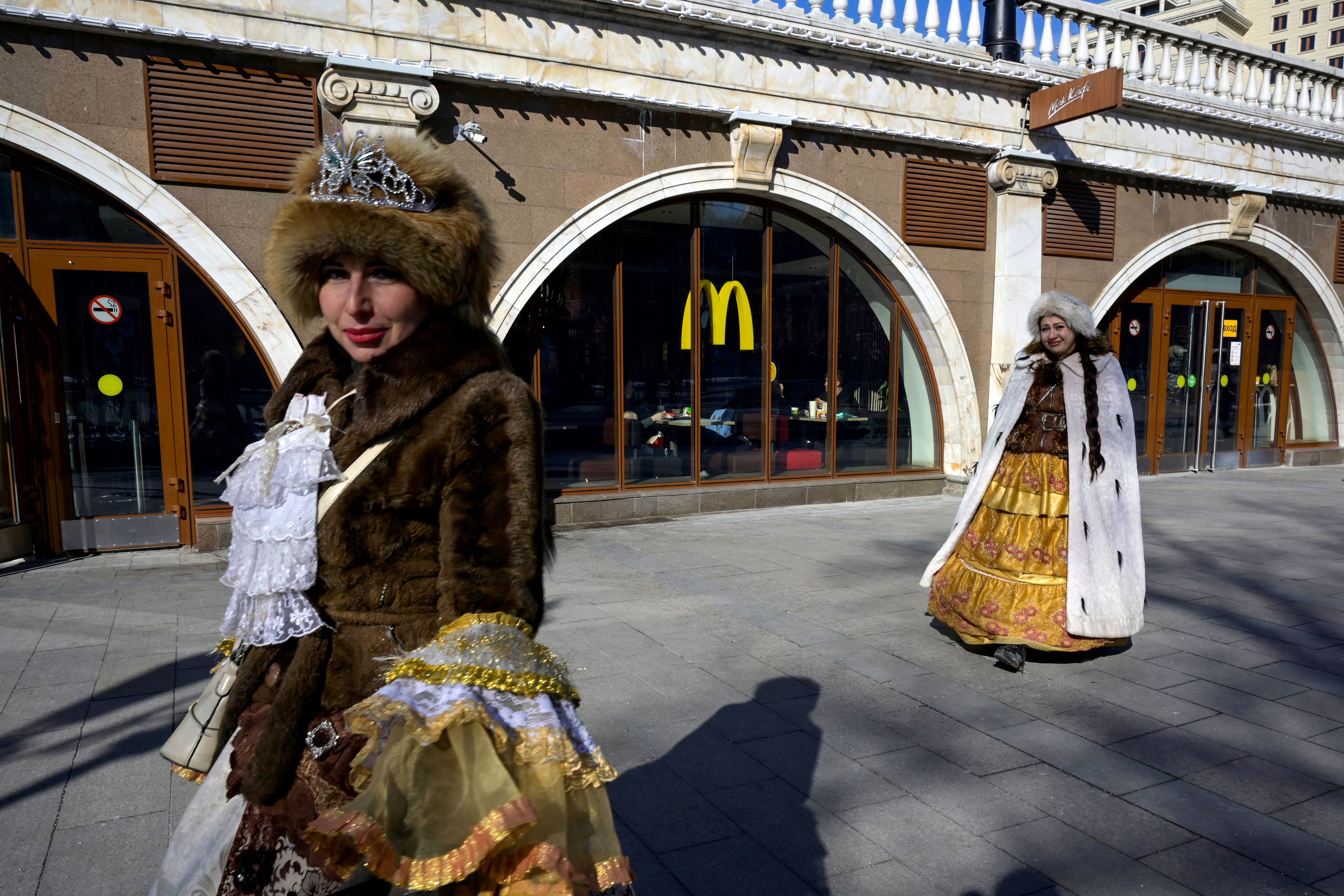 Women walk in front of a McDonald's restaurant in central Moscow on March 9, 2022.