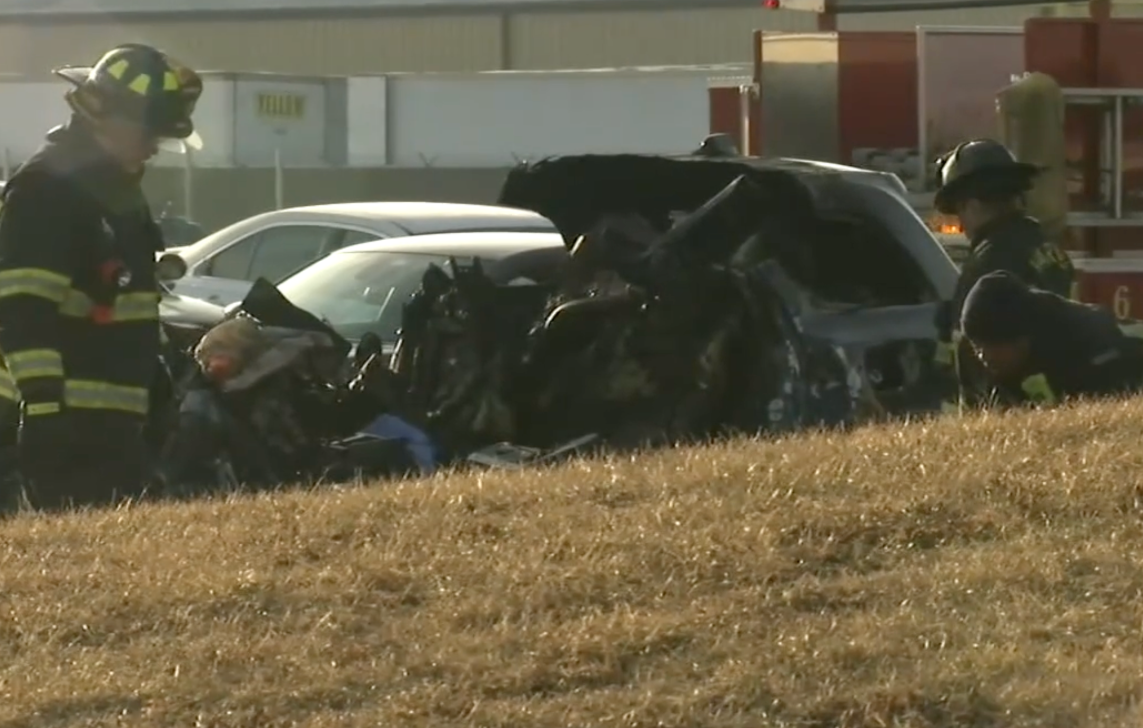 Four people were killed when a train crashed into an SUV at a Chicago rail crossing on 9 March 2022. Fire crews are seen next to the wrecked vehicle