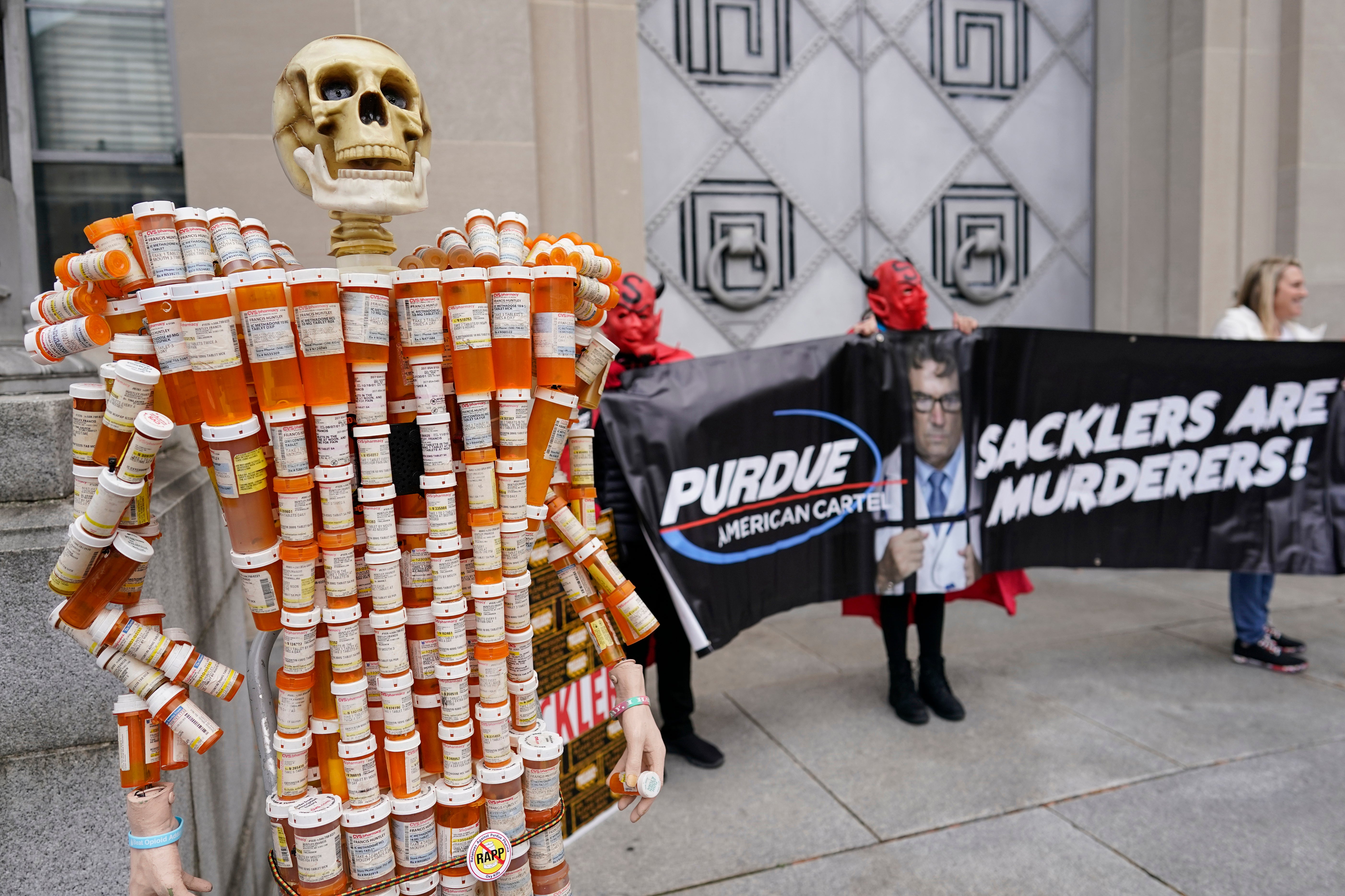 ‘Pill Mann’ made by Frank Huntley from his opioid prescription pill bottles, is displayed during a protest by advocates for opioid victims outside the Department of Justice, on Dec. 3, 2021