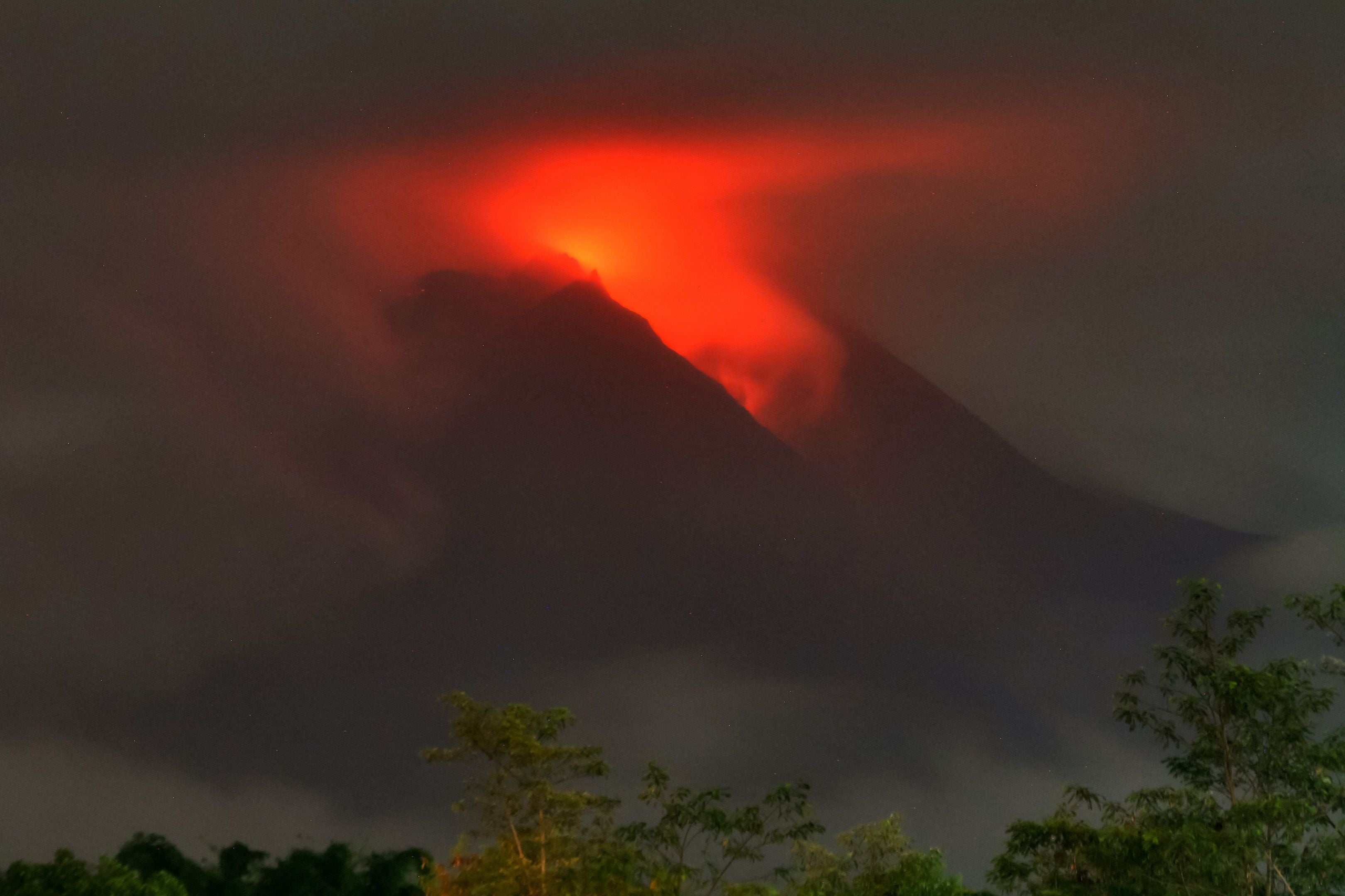 Lava flows down from the crater of Indonesia's most active volcano Mount Merapi, seen from the village of Plunyon in Sleman