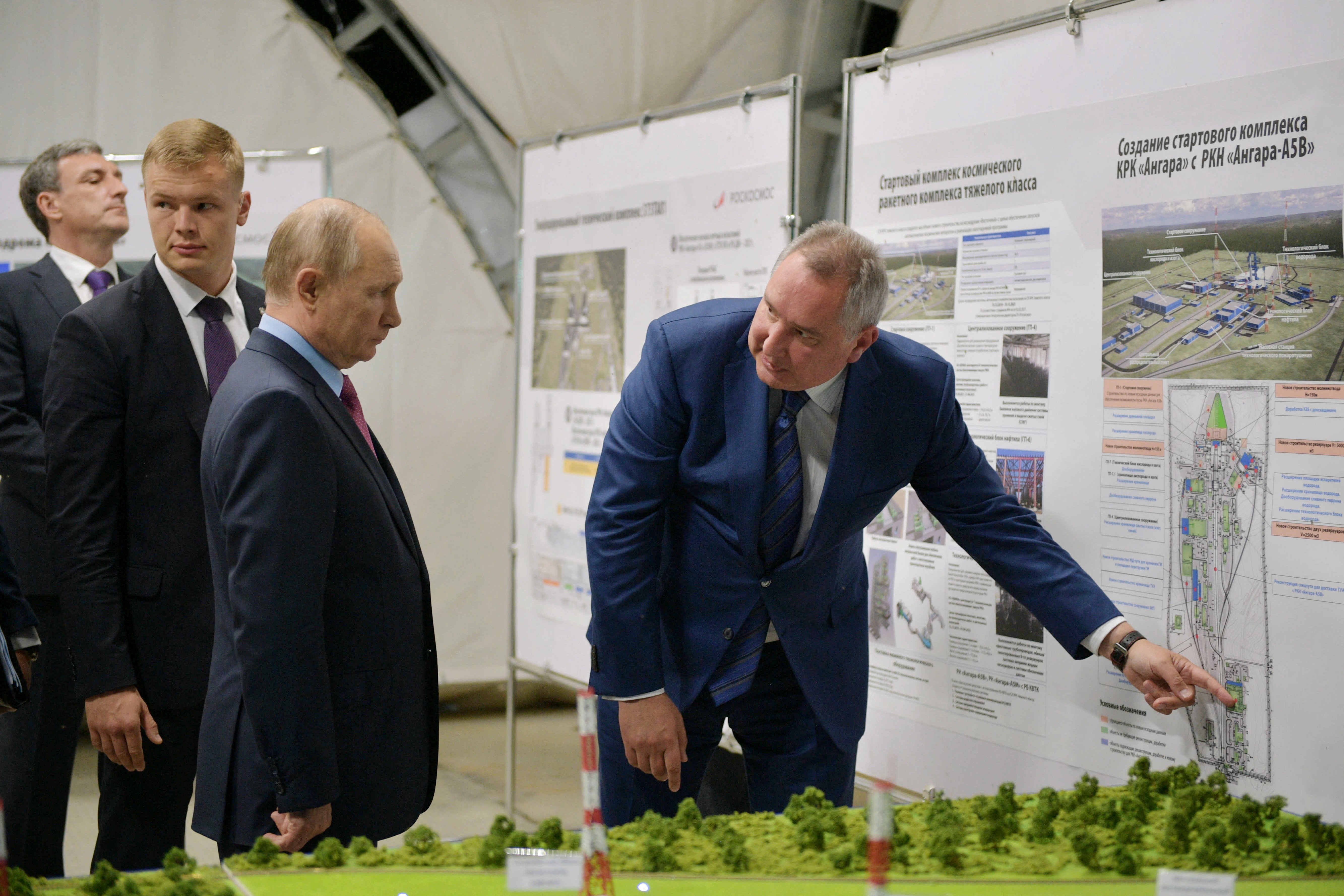 Russian President Vladimir Putin (C) listens to head of Russia’s space agency Roscosmos Dmitry Rogozin (L), as they visit the Vostochny cosmodrome, Amur region, on 4 September 2021