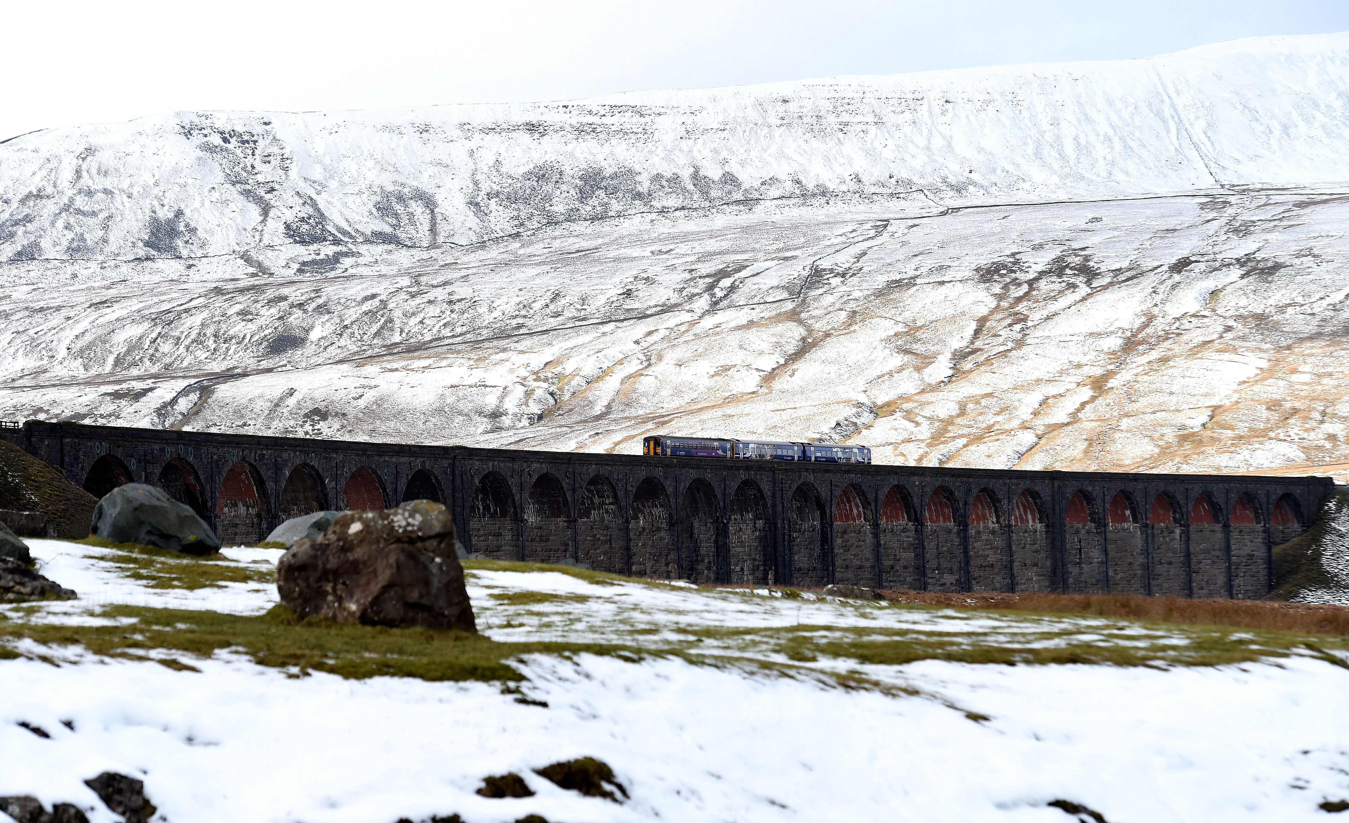 A TransPennine train crosses Ribblehead Viaduct in North Yorkshire (Owen Humphreys/PA)