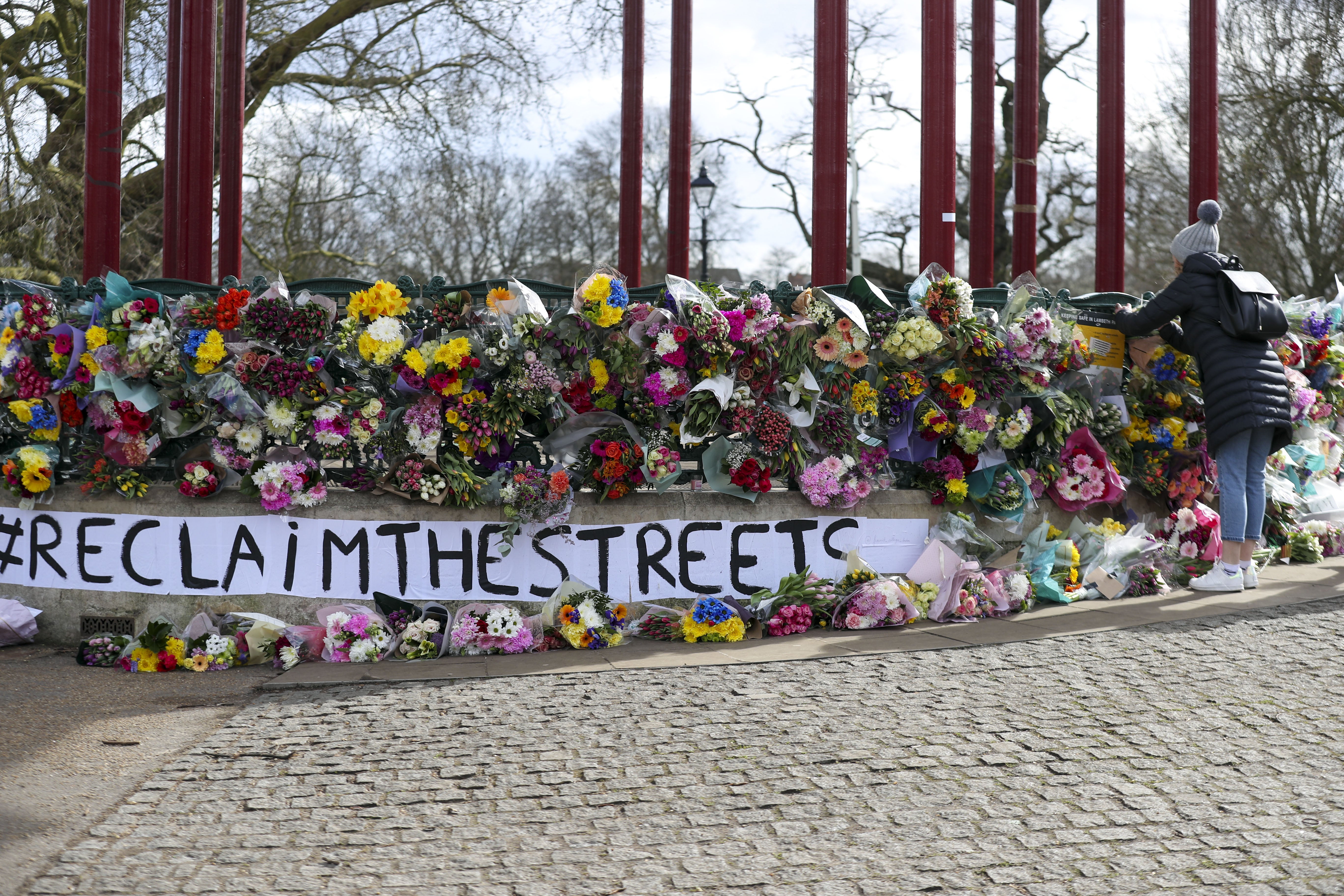 People leave floral tributes at the band stand in Clapham Common, London, after the Reclaim These Streets vigil for Sarah Everard was officially cancelled (Steve Parsons/PA)