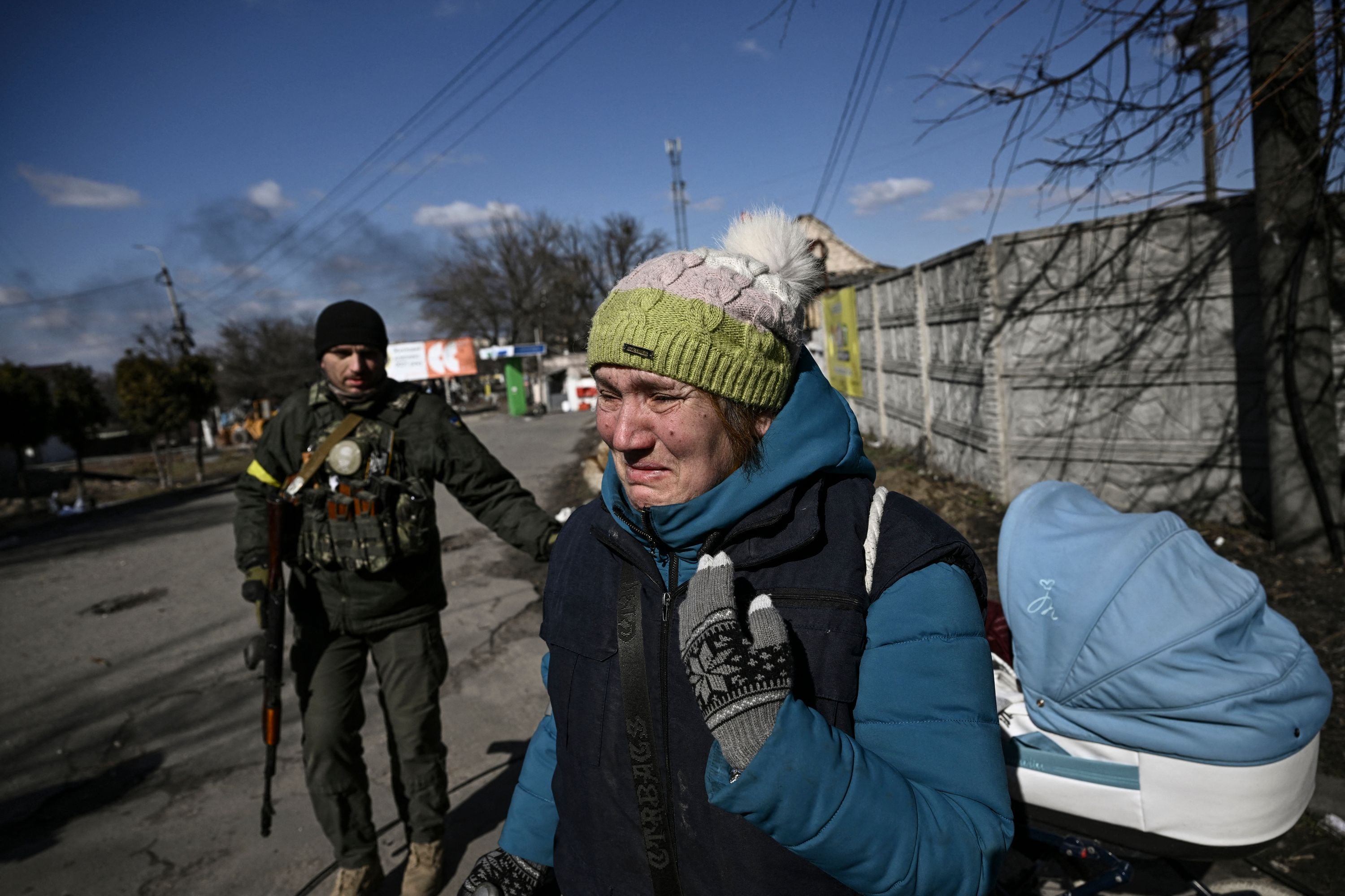 A resident cries as she evacuates the city of Irpin, north of Kyiv