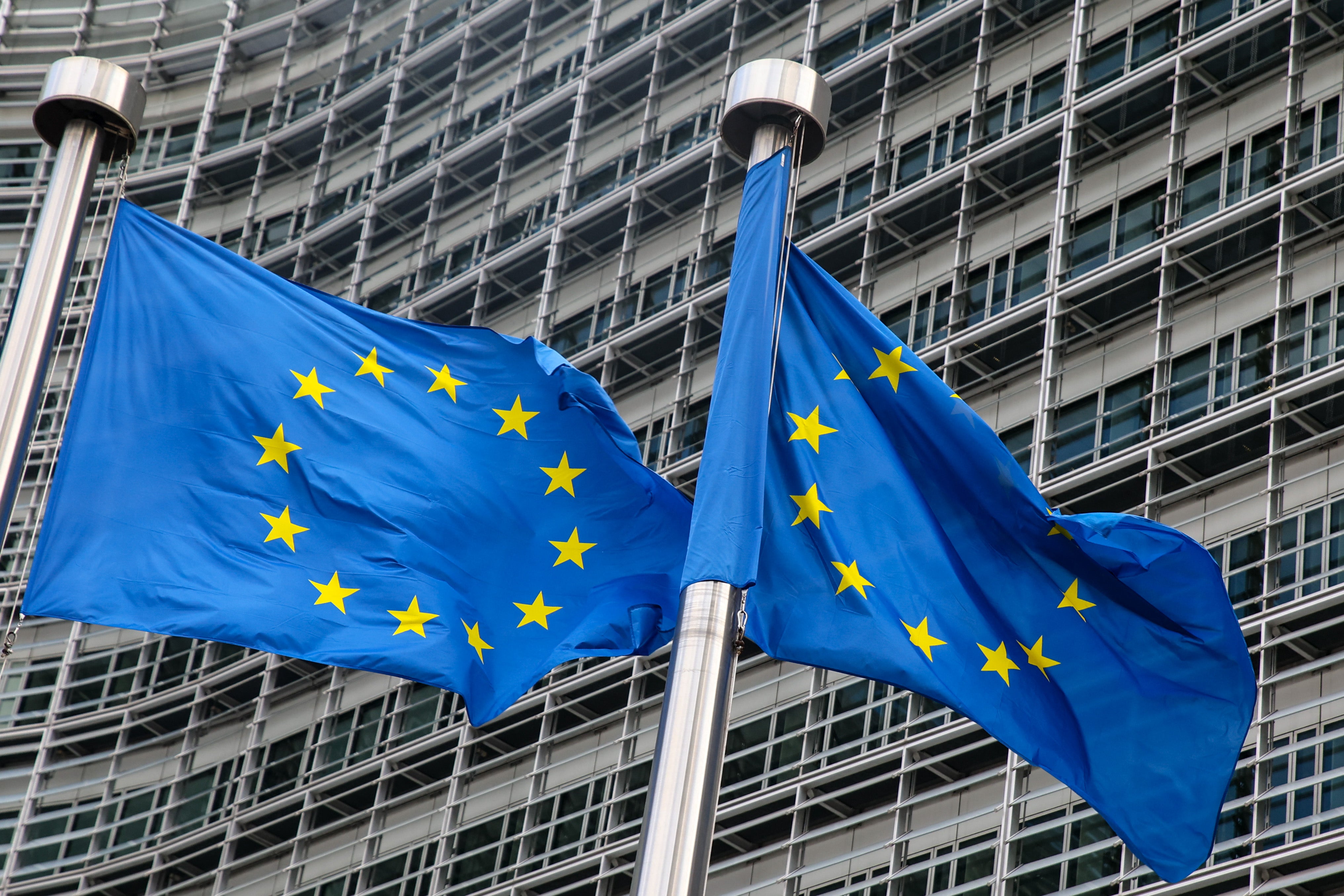 European Union flags fly outside the headquarters of the European Commission in Brussels