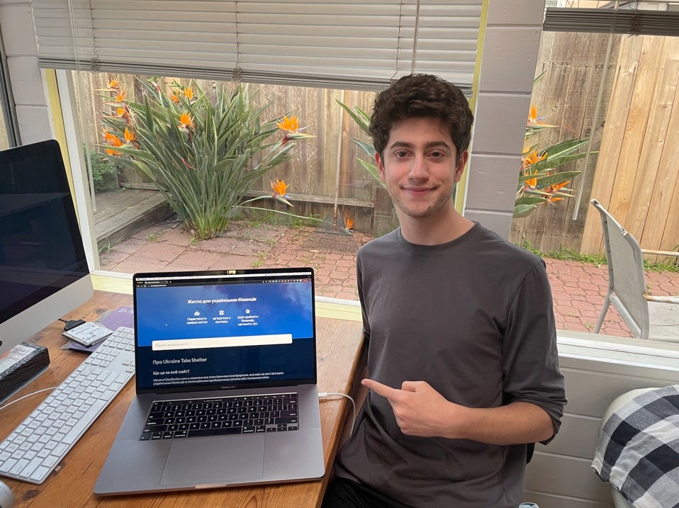 Avi Schiffmann pictured in front of a laptop showing his website Ukraine Take Shelter